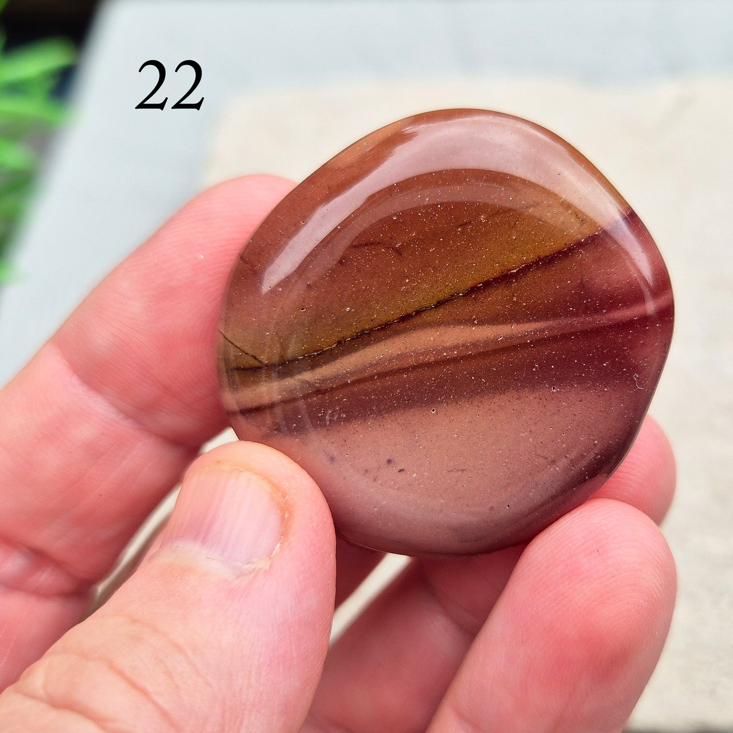 Mookaite Crystal Palm Stone. From the Mooka Creek region in Western Australia, each Mookaite palm stone displays a unique mix of earthy tones—reds, yellows, creams, and purples. 