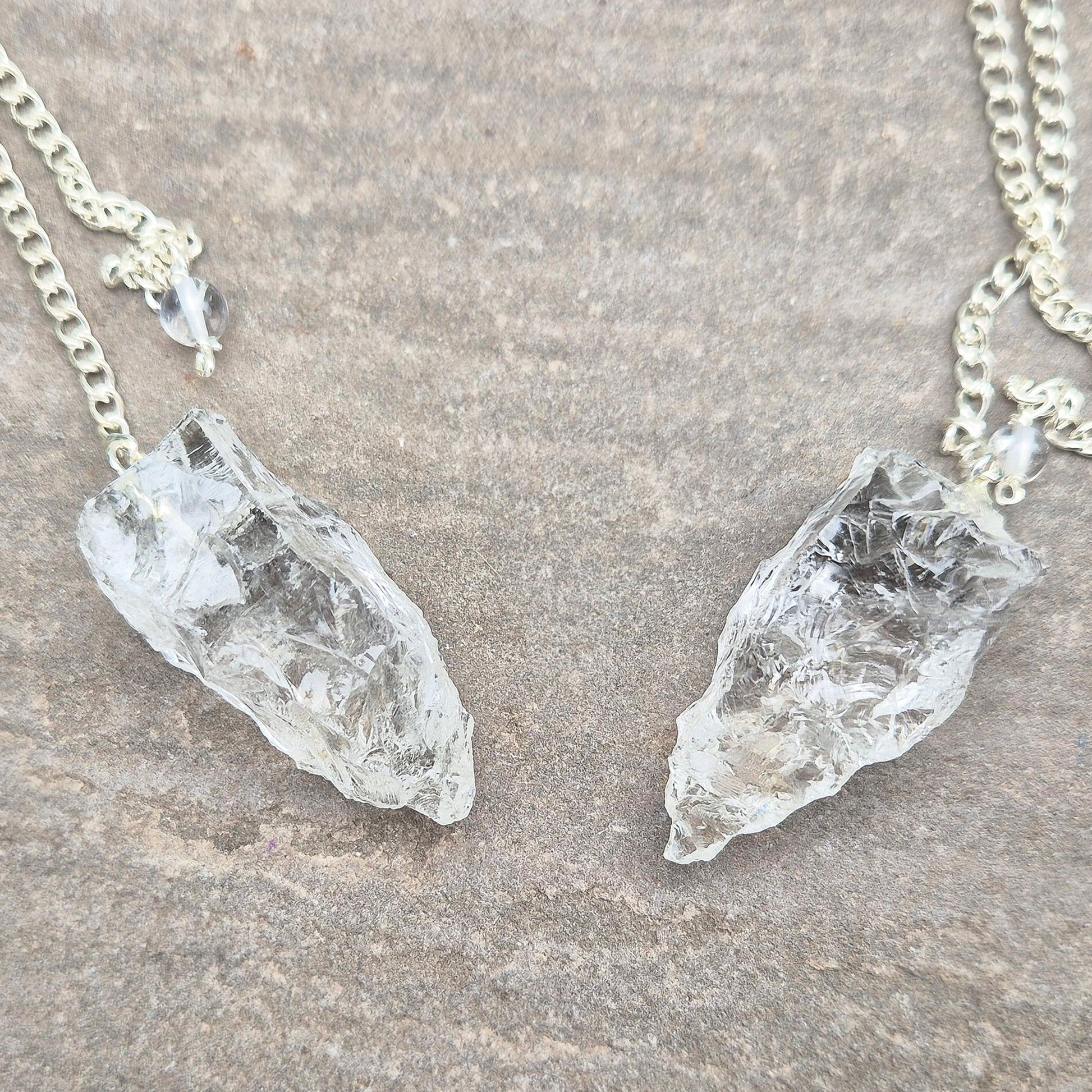 This Rock Quartz Crystal Pendulum from Brazil features a natural quartz crystal and a white bead at the end of the chain.