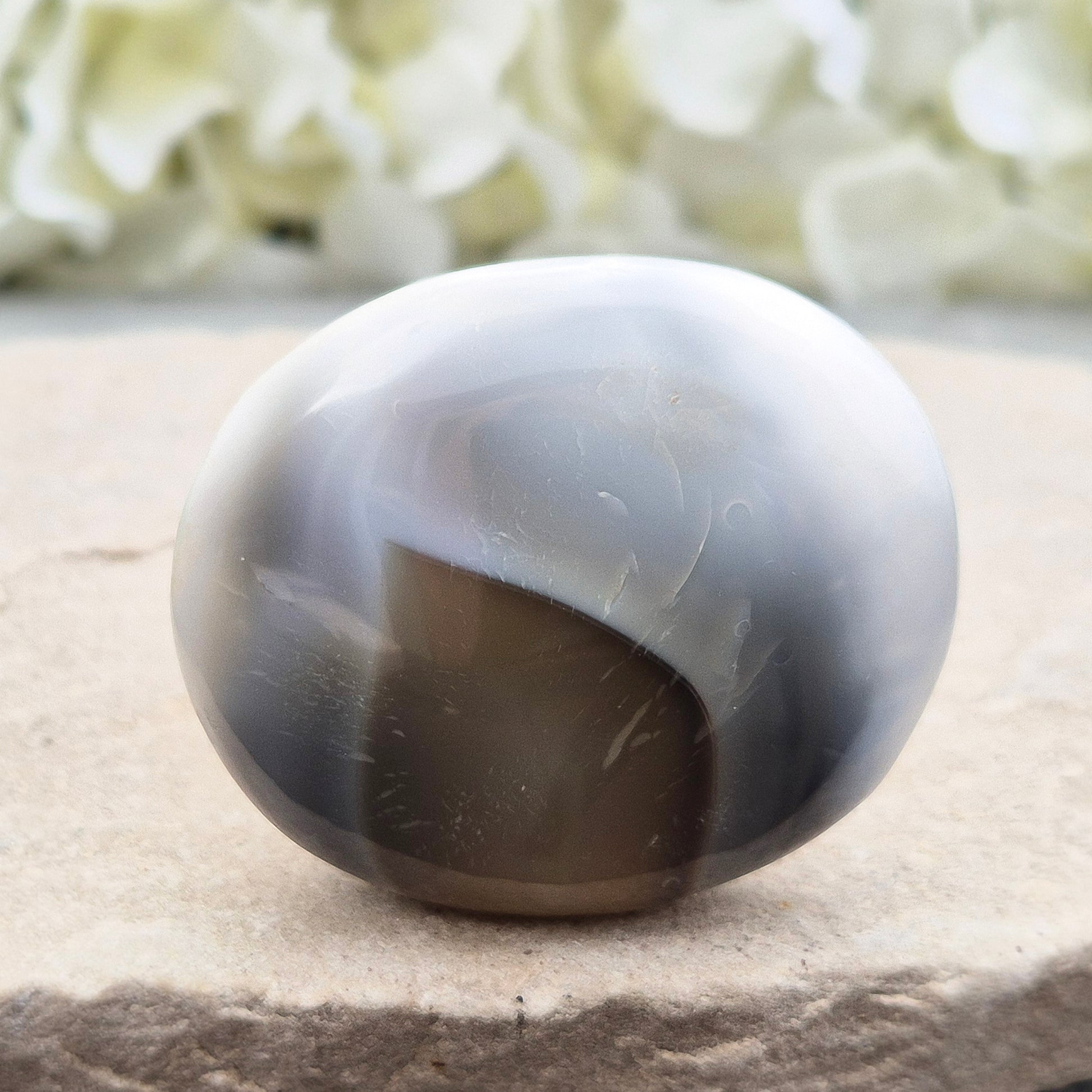 Orca Agate Crystal Pebble. This beautiful Orca Agate crystal, also known as Grey Agate, comes from Madagascar and is named after the Orca whale. It has striking brown/grey and white patterning and colouring. 