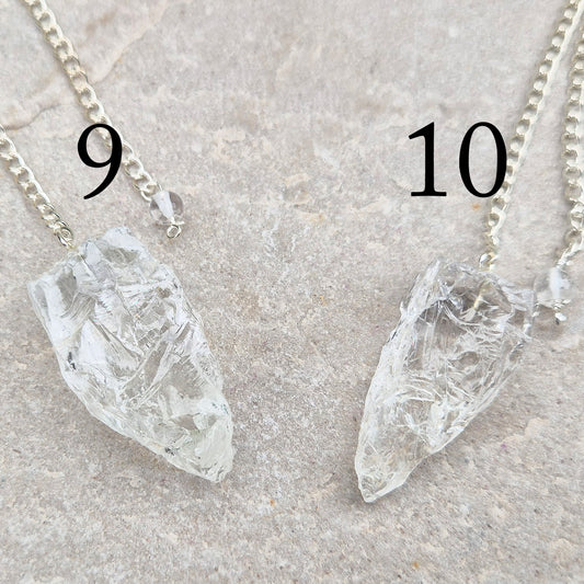This Rock Quartz Crystal Pendulum from Brazil features a natural quartz crystal and a white bead at the end of the chain.&nbsp;It will come with a card and pouch for safe keeping. 