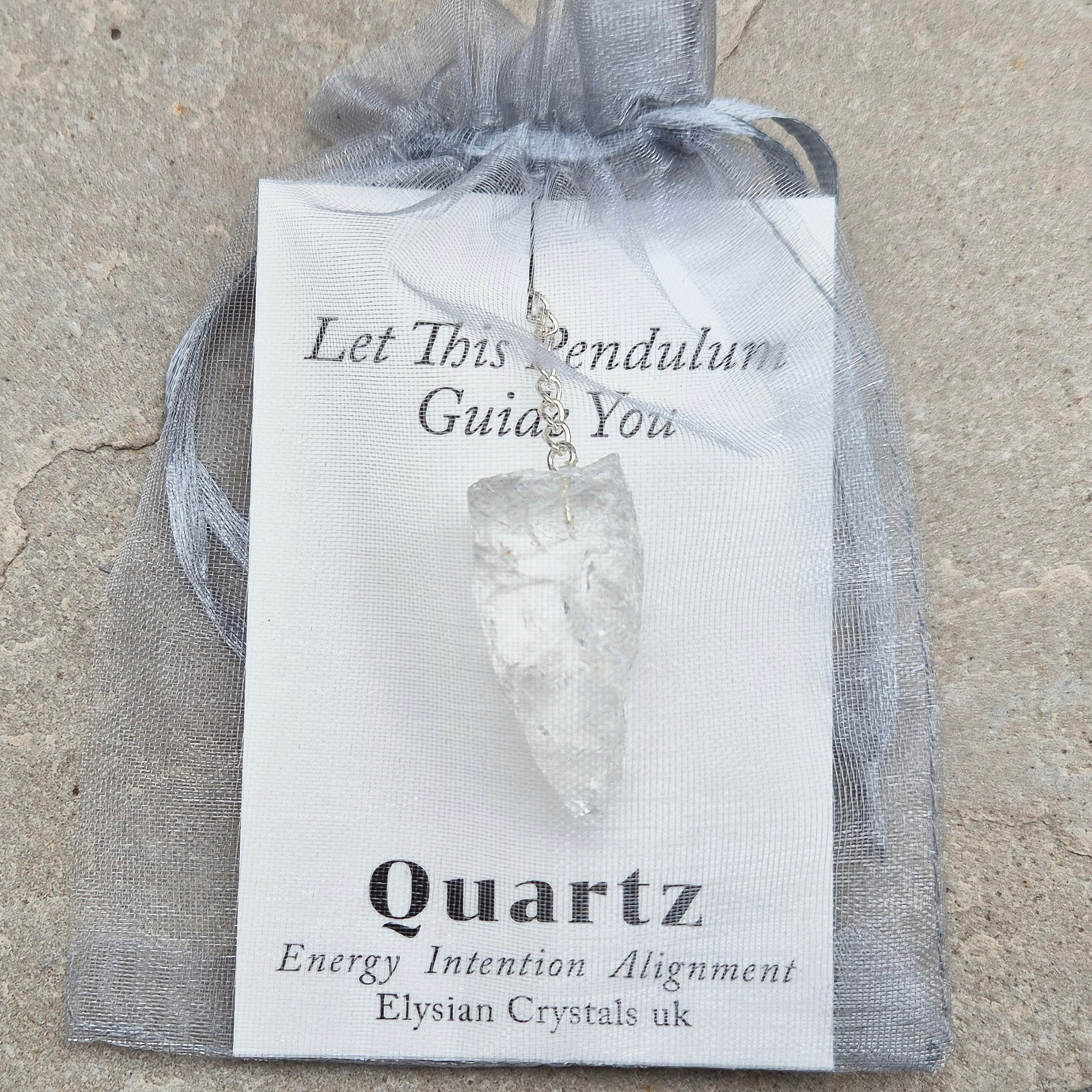 This Rock Quartz Crystal Pendulum from Brazil features a natural quartz crystal and a white bead at the end of the chain.&nbsp;It will come with a card and pouch for safe keeping. 