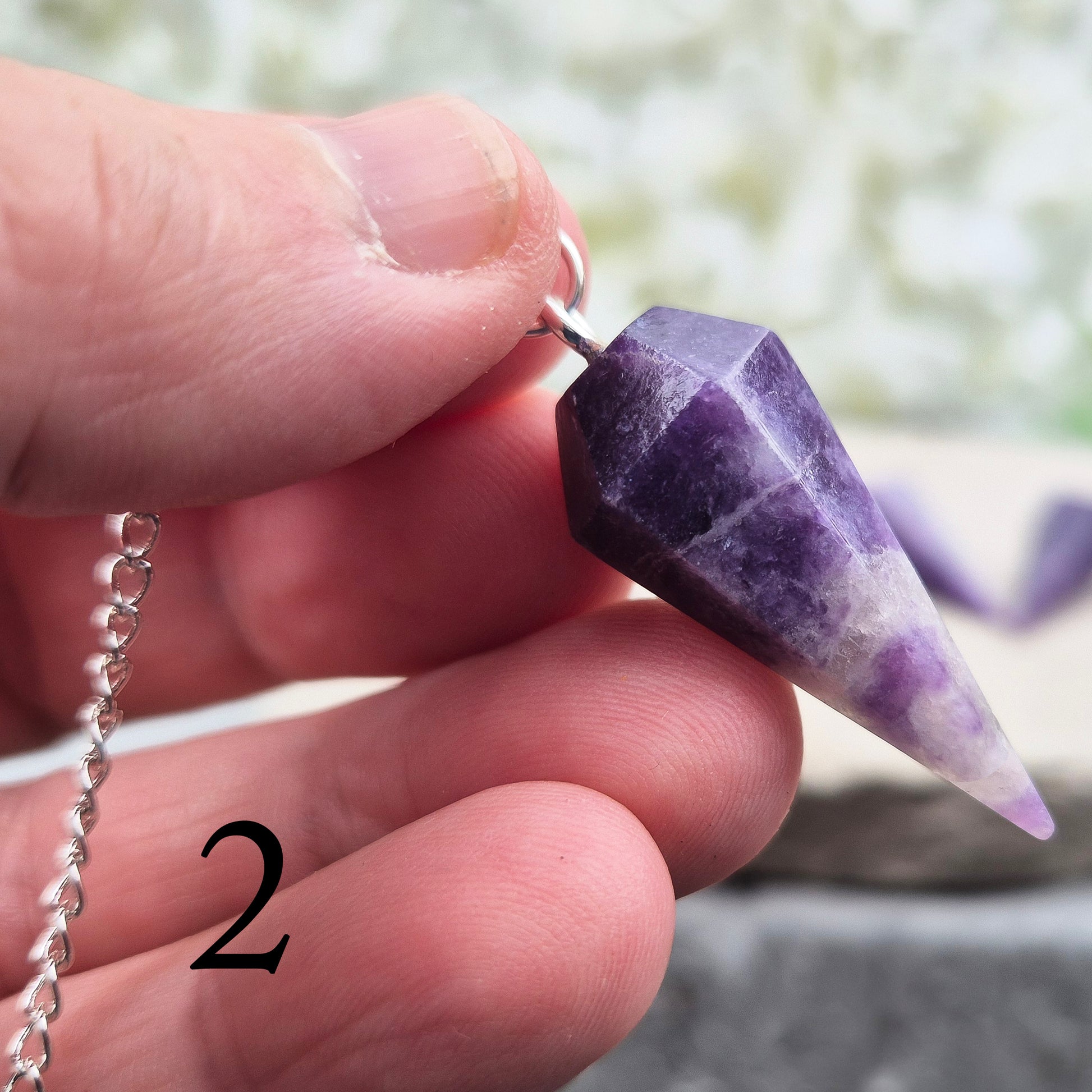 This Lepidolite Crystal Pendulum shows off beautiful deep purple colouring. Lepidolite is valued for its soothing, balancing energy – a gentle aid when working through stress, change, or emotional shifts.