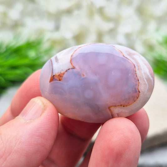 This Moroccan Agate palm stone has been polished and shaped to fit comfortably in the hand, making it perfect for daily use.