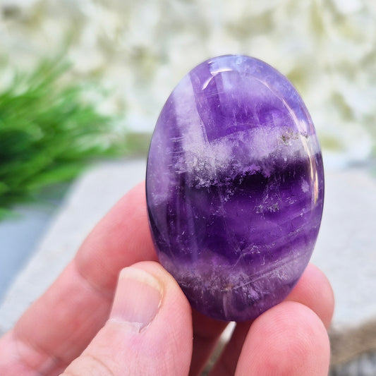 Polished Chevron Amethyst palm stone. Blends Amethyst and Quartz energy for cleansing, calm, courage, and spiritual awareness.