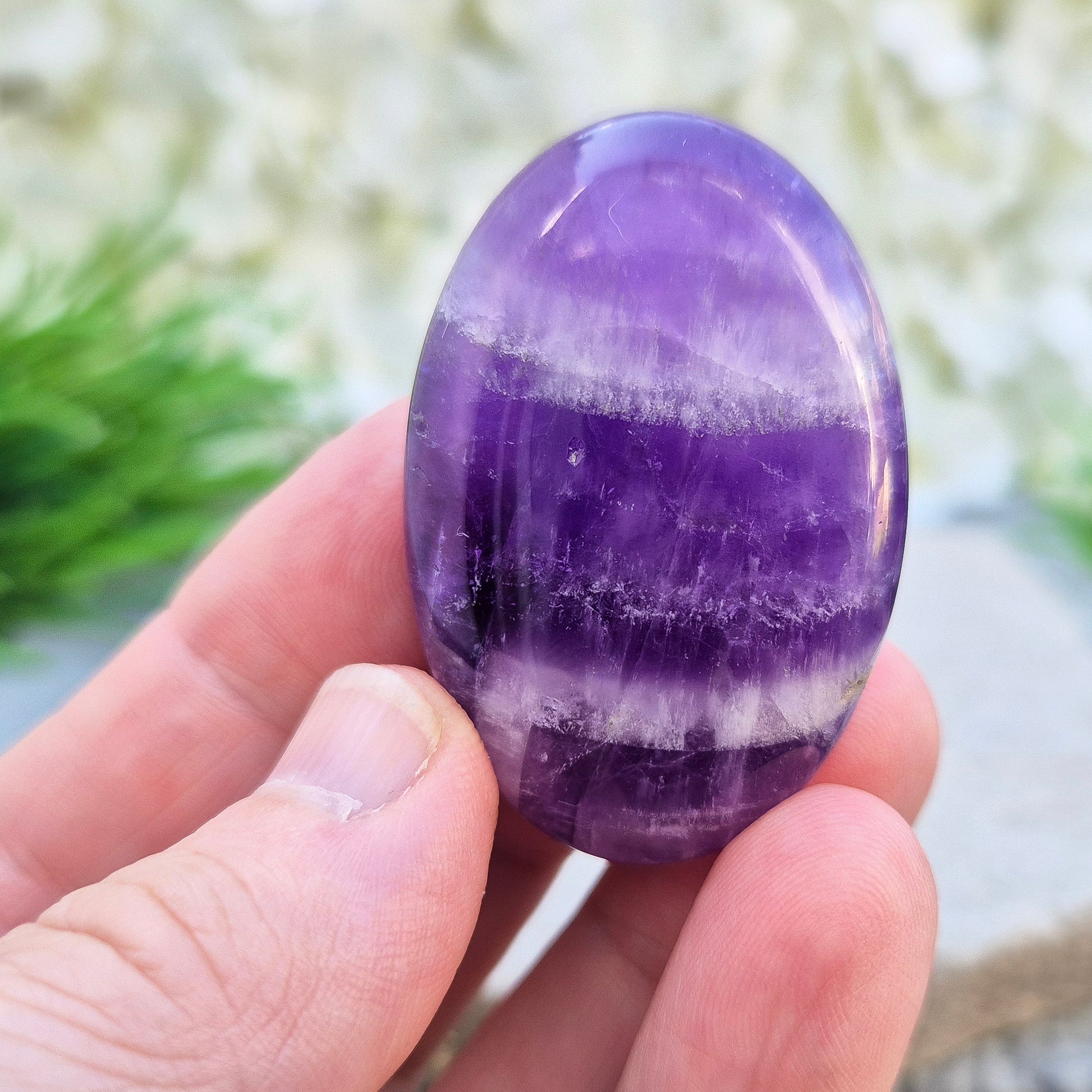 Polished Chevron Amethyst palm stone. Blends Amethyst and Quartz energy for cleansing, calm, courage, and spiritual awareness.