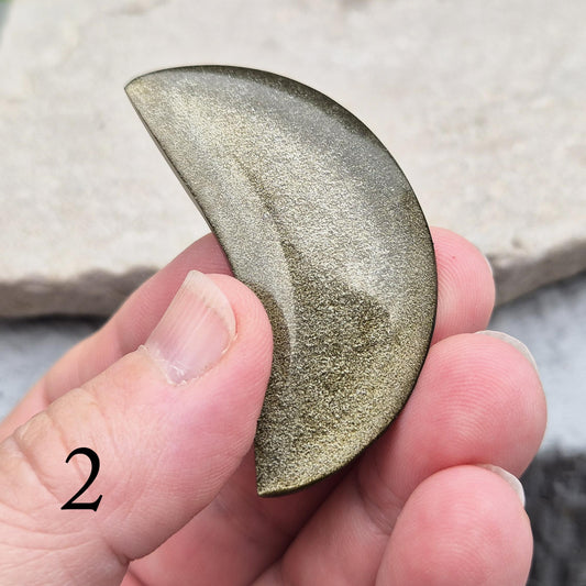 Gold Sheen Obsidian crescent moons from Mexico. Protective and empowering crystals that reveal truth, clear energy, and attract confidence and prosperity.