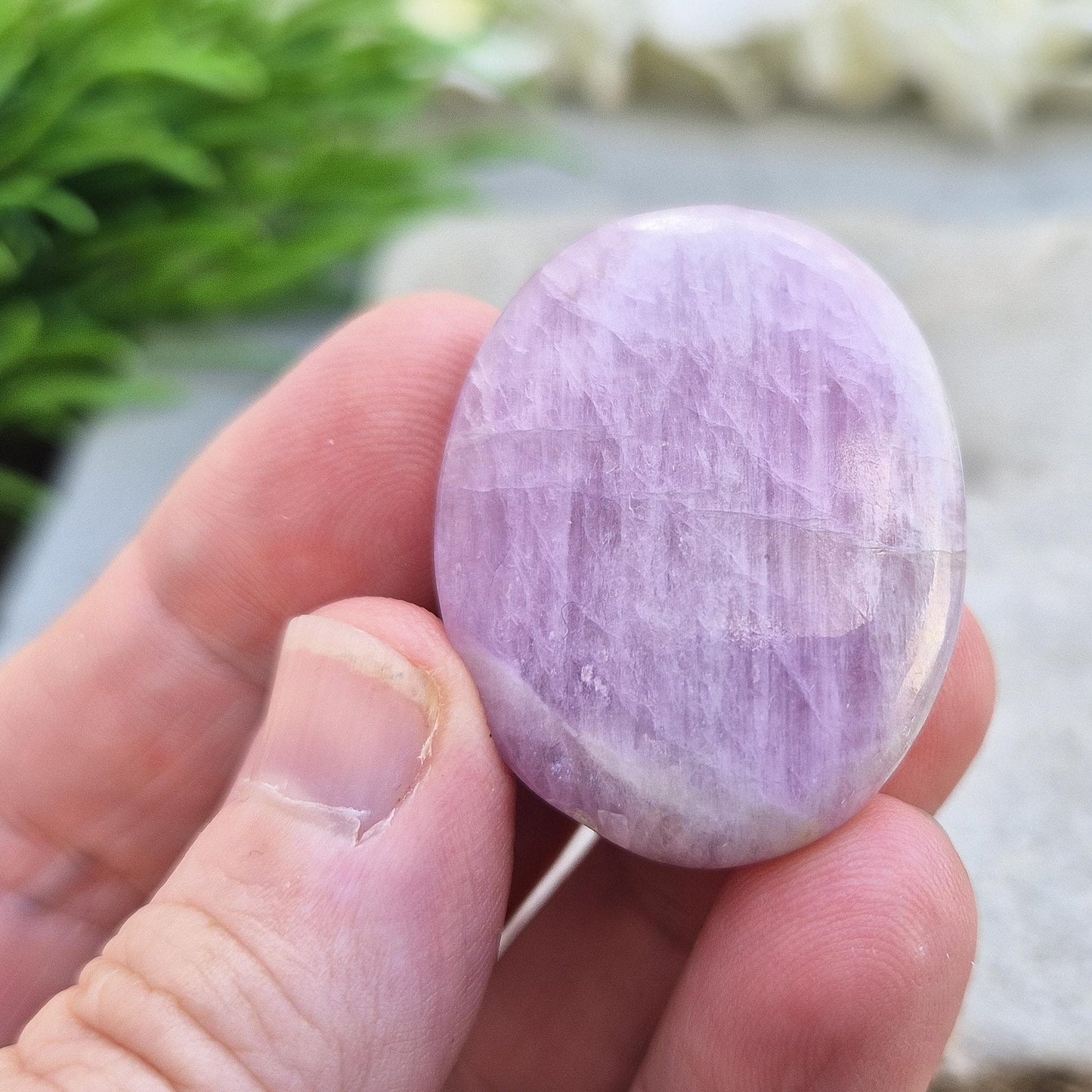 Polished lilac Kunzite palm stone. High-vibration crystal that calms the mind, opens the heart, protects the aura, and supports meditation. 