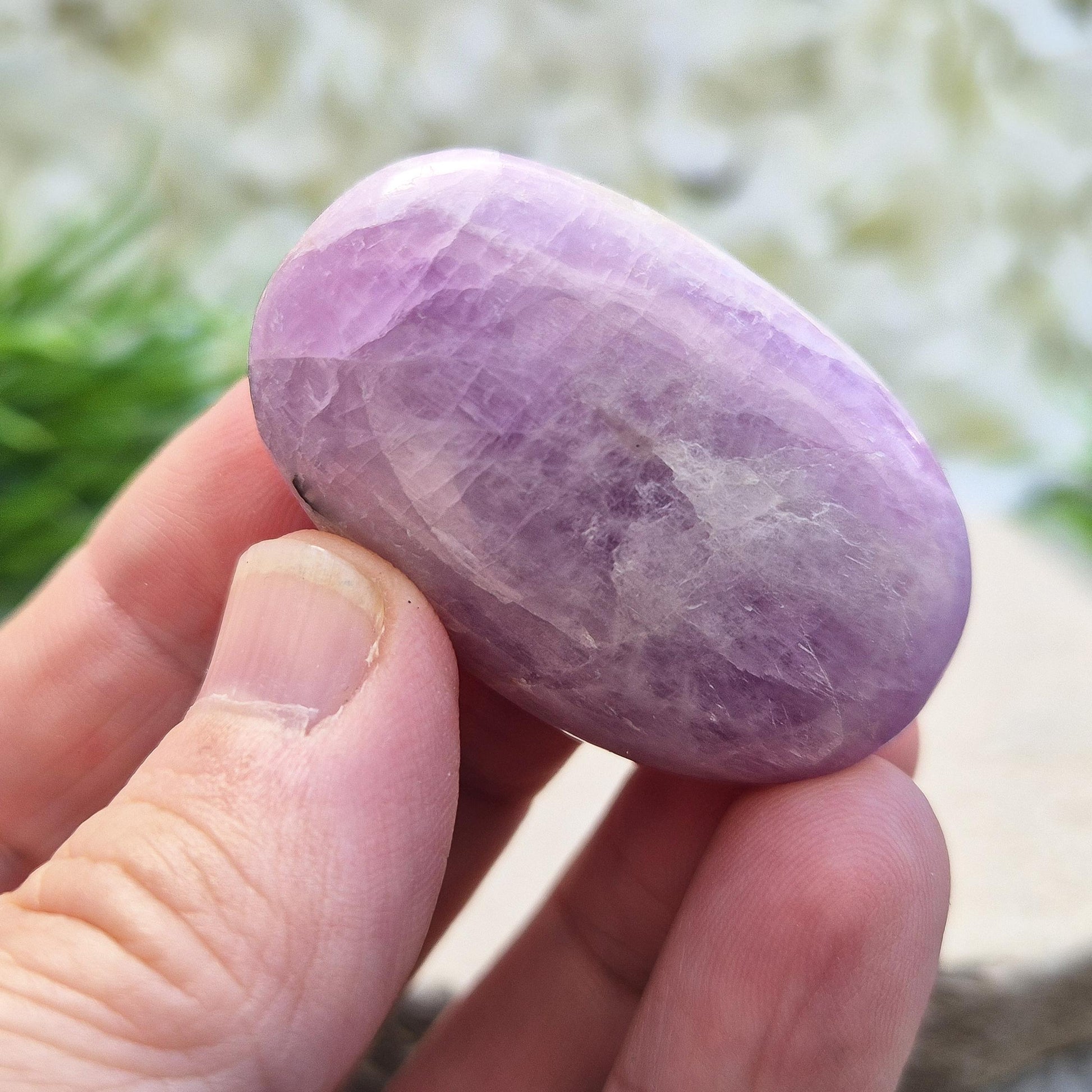 Polished lilac Kunzite palm stone. High-vibration crystal that calms the mind, opens the heart, protects the aura, and supports meditation. 