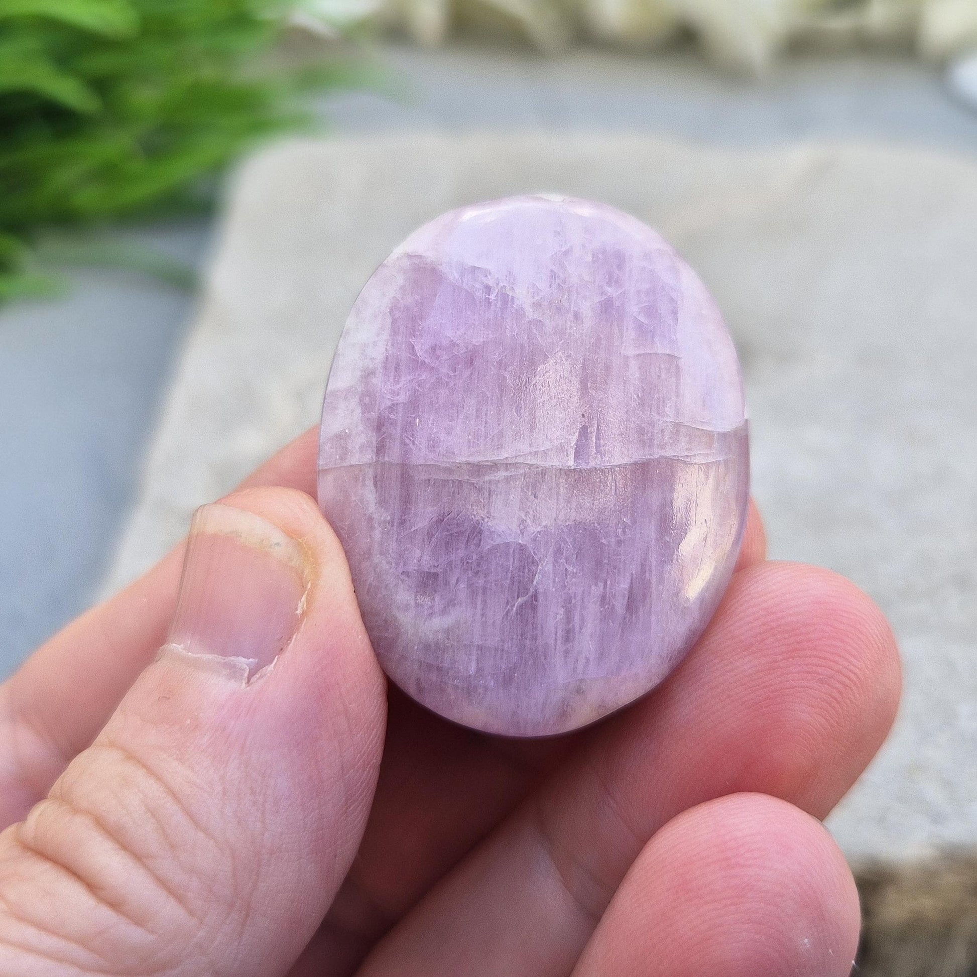 Polished lilac Kunzite palm stone. High-vibration crystal that calms the mind, opens the heart, protects the aura, and supports meditation. 