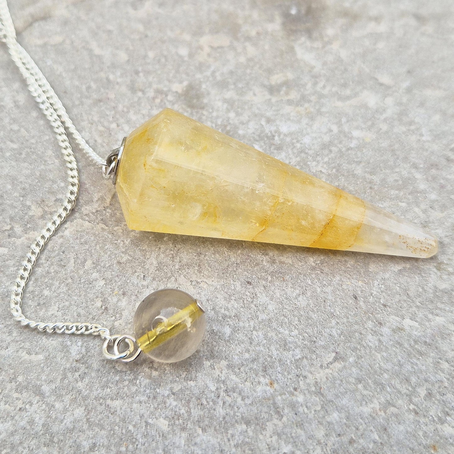 Golden Healer Quartz pendulum for energy work, dowsing, and intuitive guidance. Connects to gentle healing, balance, and spiritual growth.