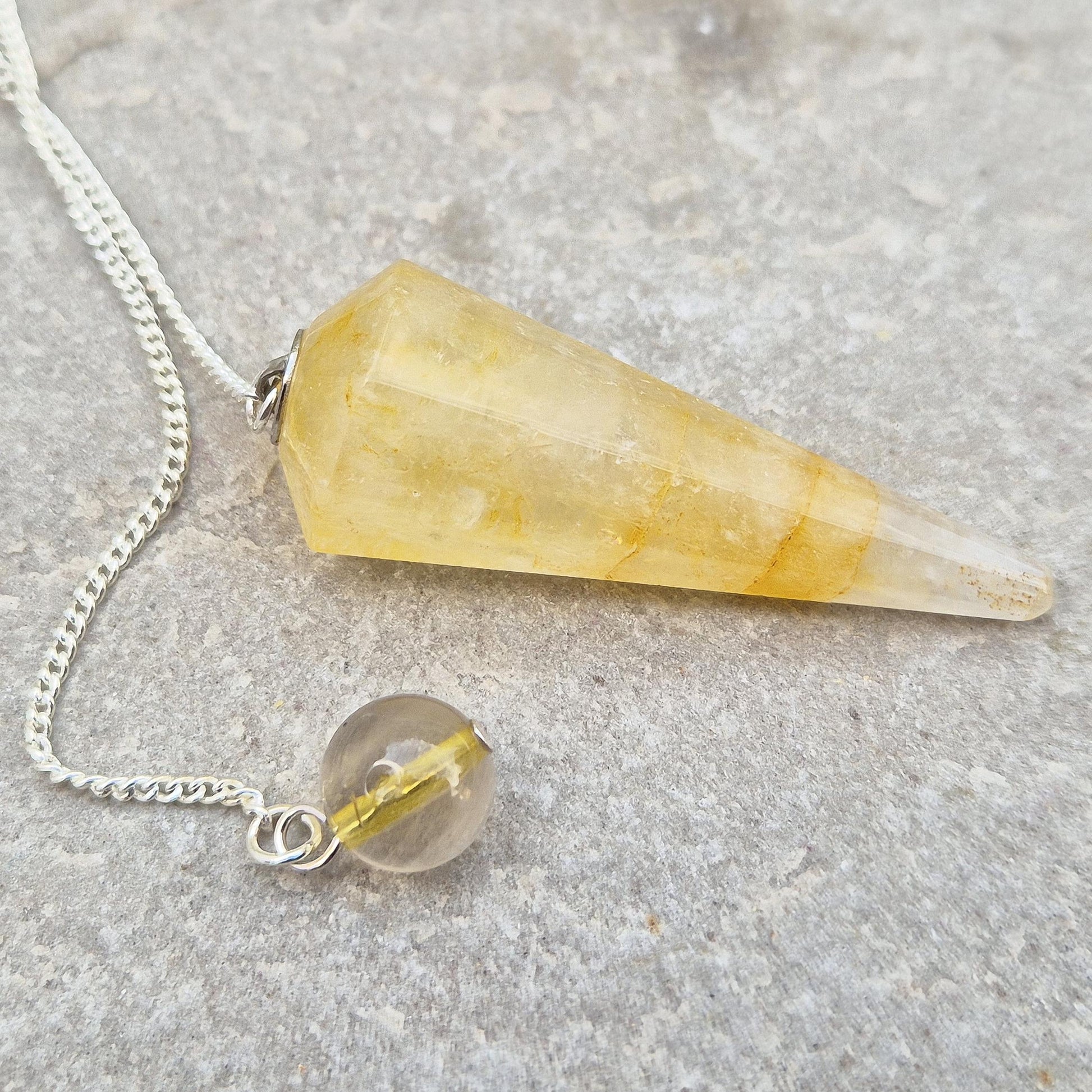 Golden Healer Quartz pendulum for energy work, dowsing, and intuitive guidance. Connects to gentle healing, balance, and spiritual growth.