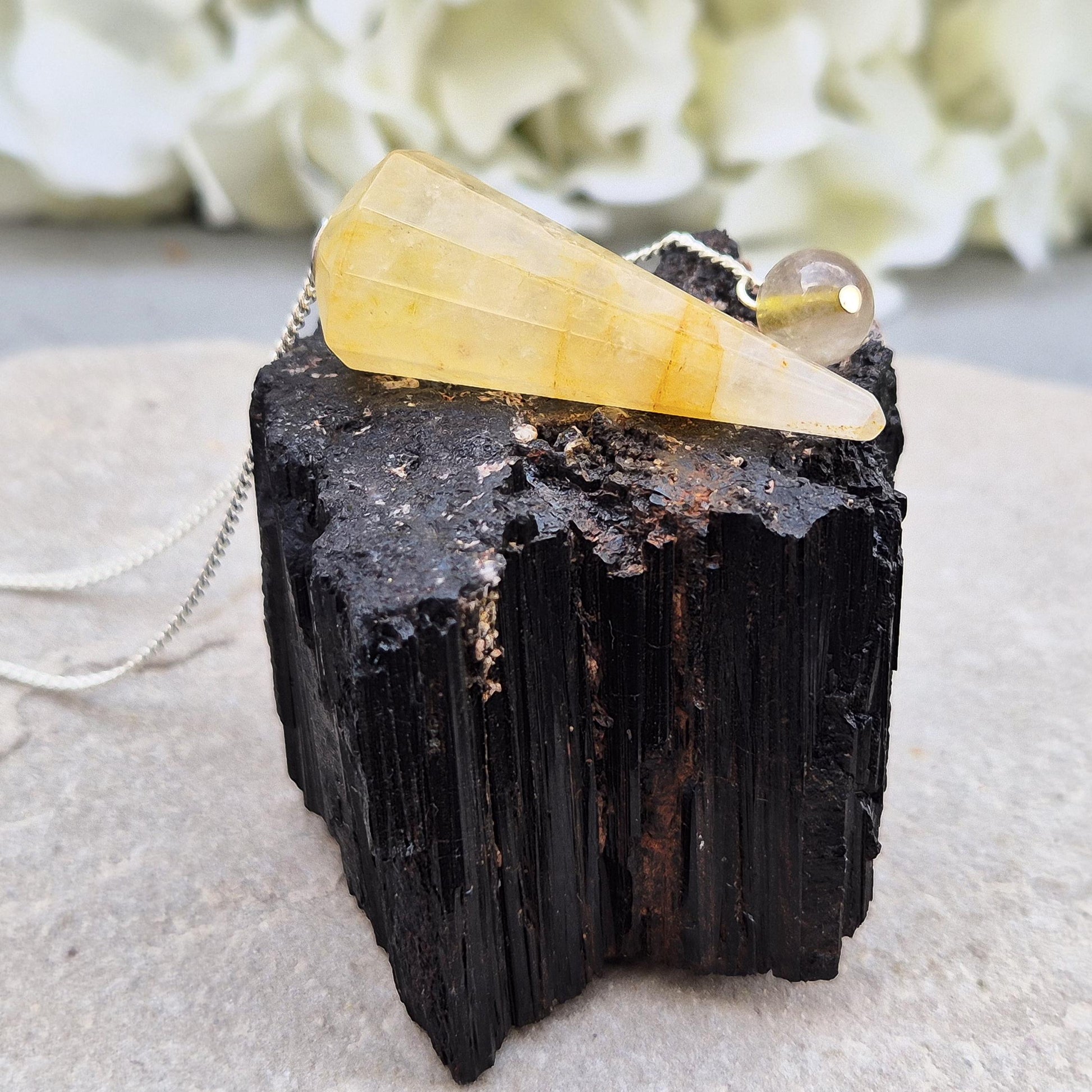 Golden Healer Quartz pendulum for energy work, dowsing, and intuitive guidance. Connects to gentle healing, balance, and spiritual growth.