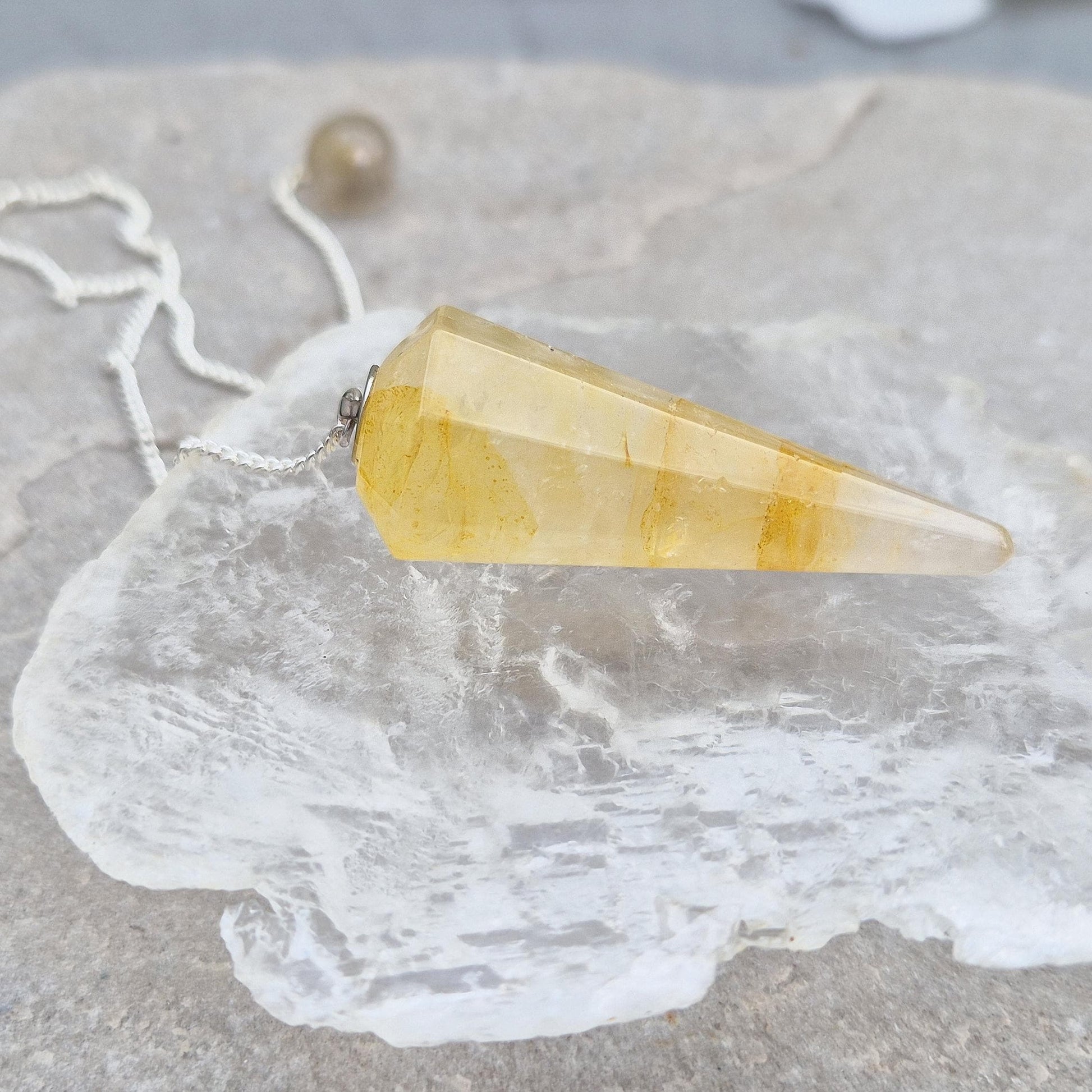 Golden Healer Quartz pendulum for energy work, dowsing, and intuitive guidance. Connects to gentle healing, balance, and spiritual growth.