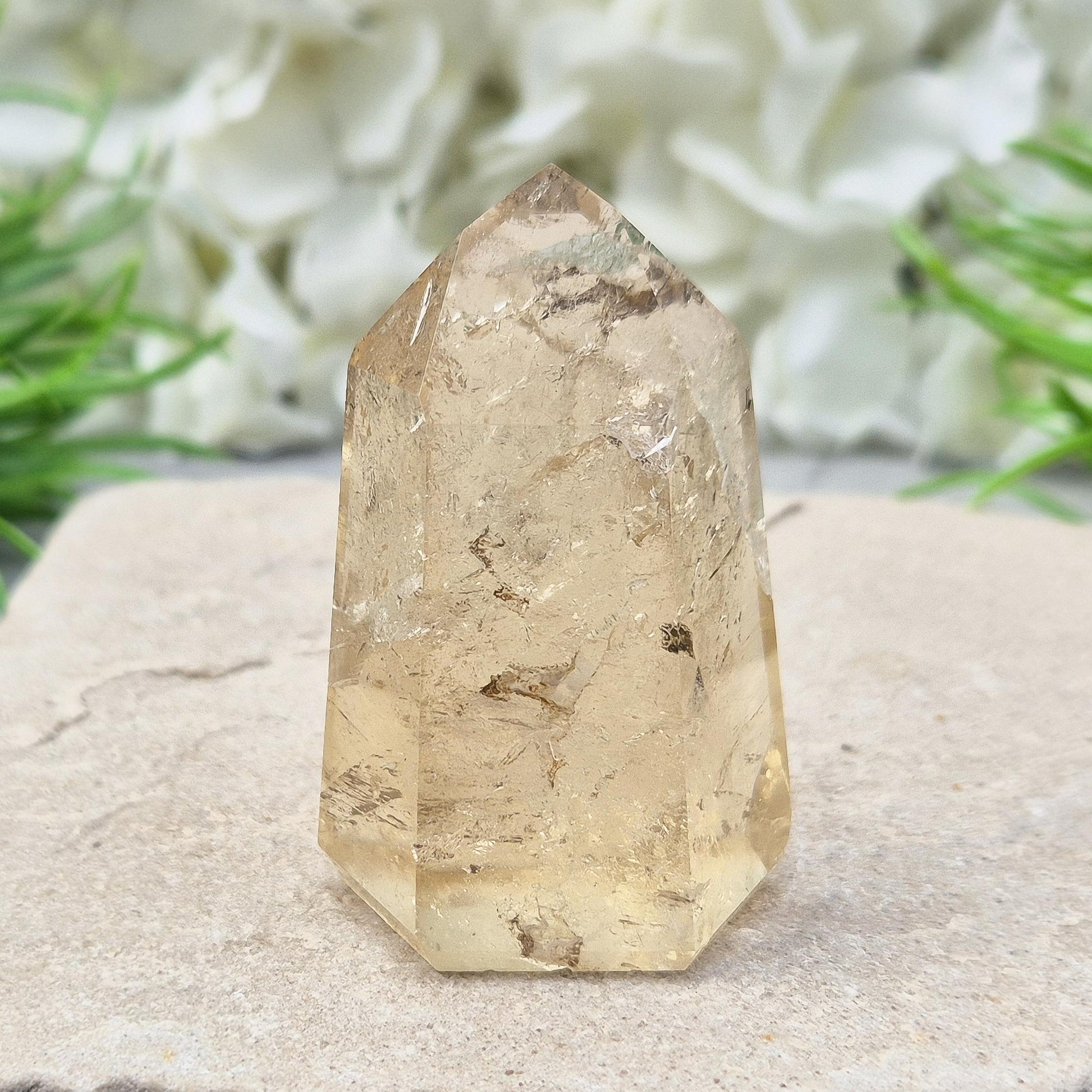 Citrine crystal point with light-reflecting inclusions. A beautiful natural piece to elevate any crystal collection. Bring joy and abundance into your life.