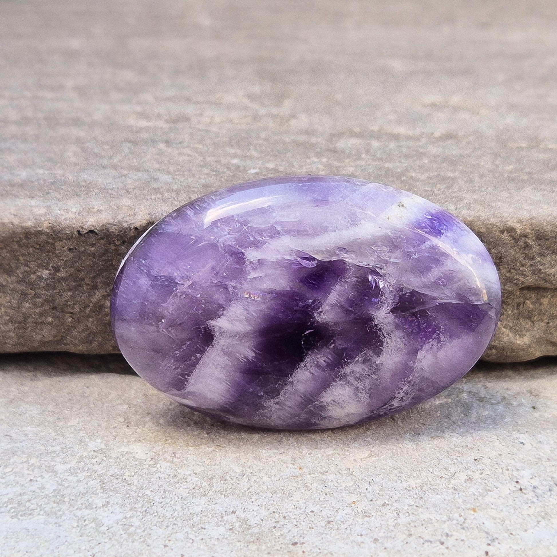 Chevron Amethyst palm stone from Brazil. A soothing crystal that supports clarity, intuition, meditation, and emotional balance. 