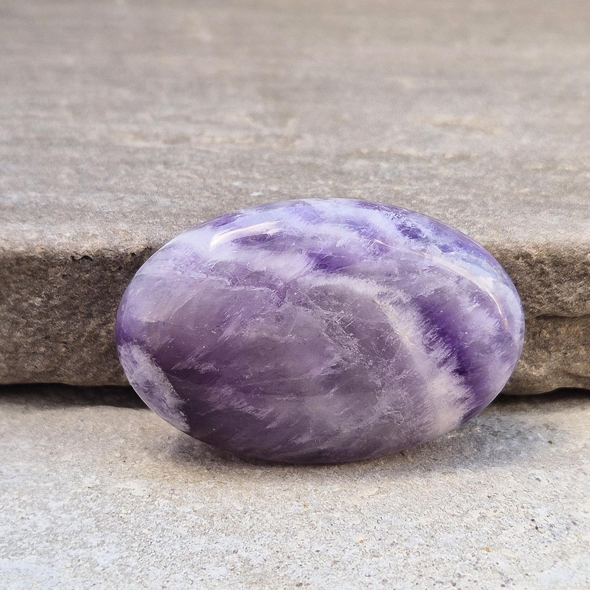Chevron Amethyst palm stone from Brazil. A soothing crystal that supports clarity, intuition, meditation, and emotional balance. 