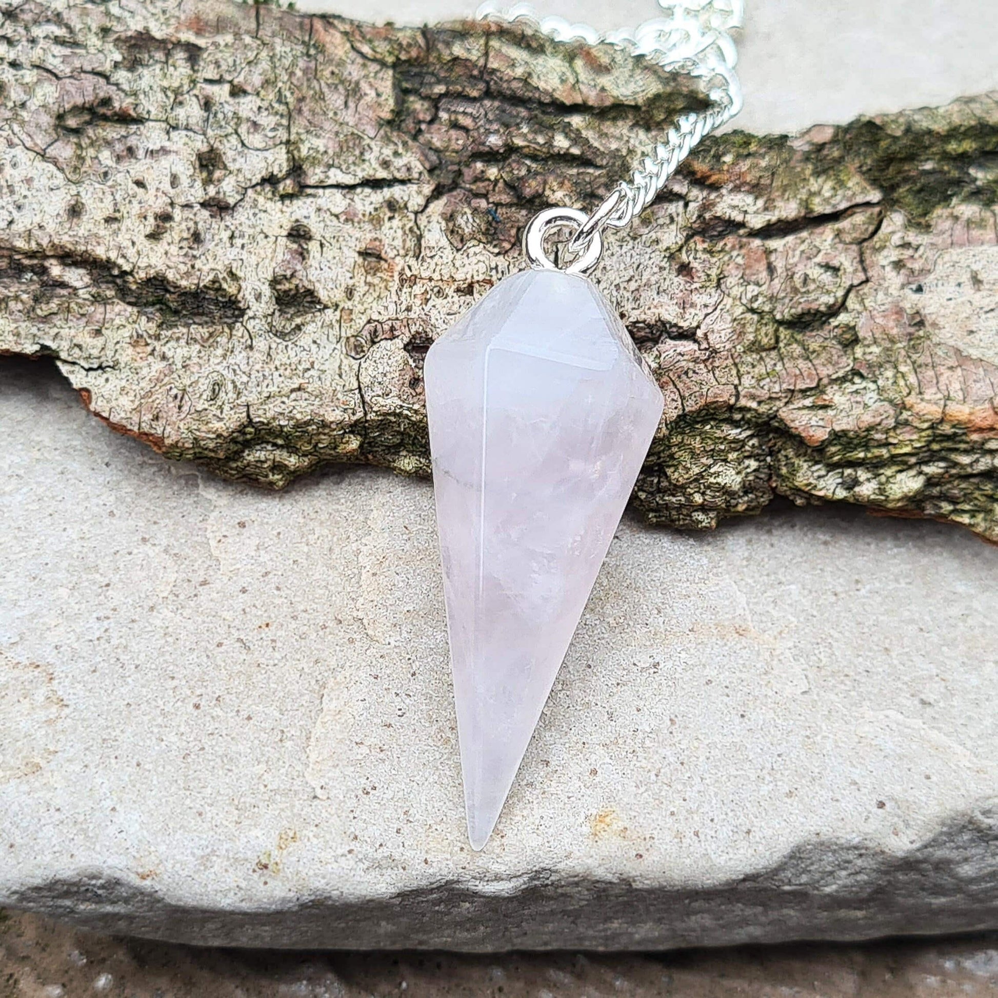 Lunar Rose Quartz Crystal Pendulum ideal for emotional support and physical wellness. Find calm and balance with this powerful tool.