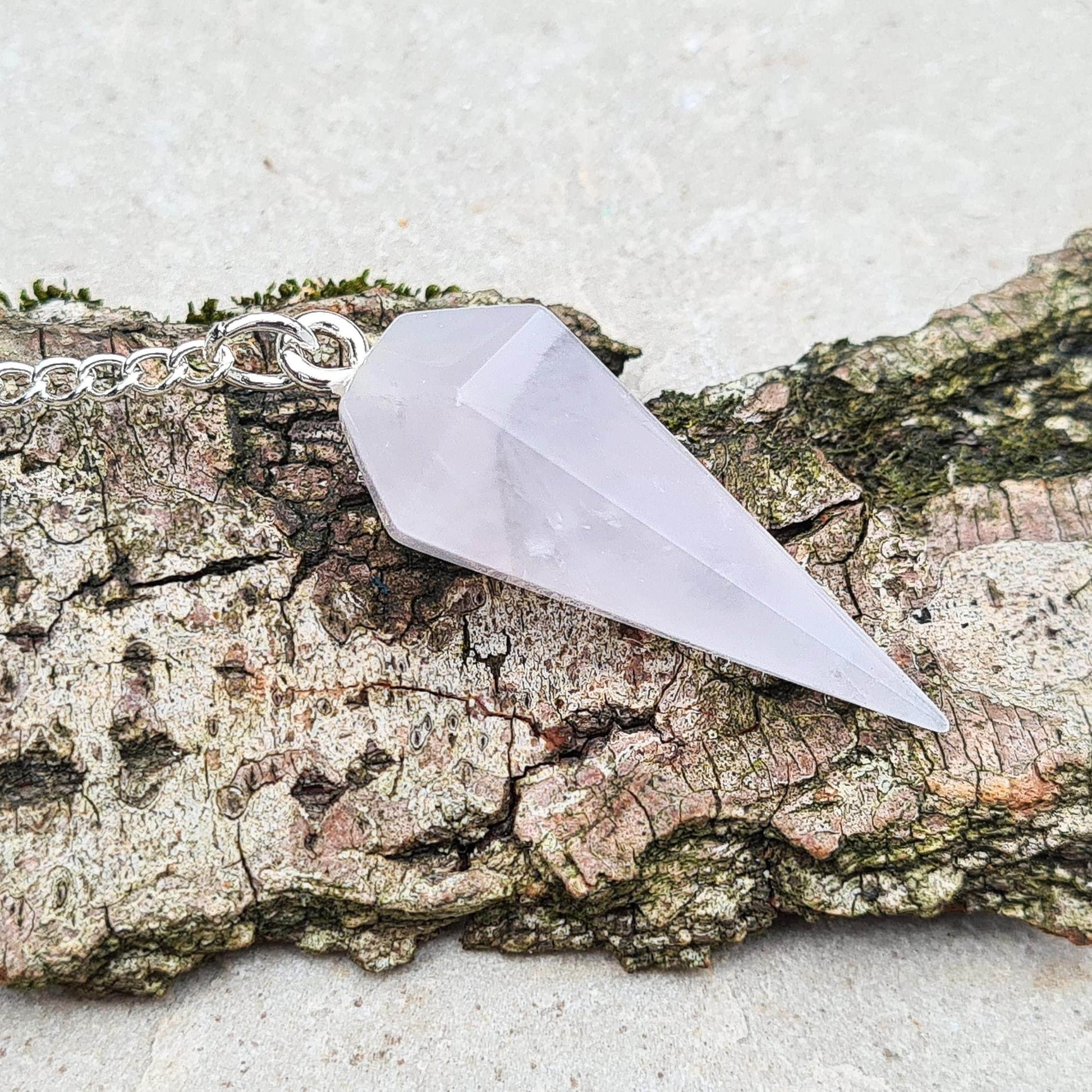 Lunar Rose Quartz Crystal Pendulum ideal for emotional support and physical wellness. Find calm and balance with this powerful tool.