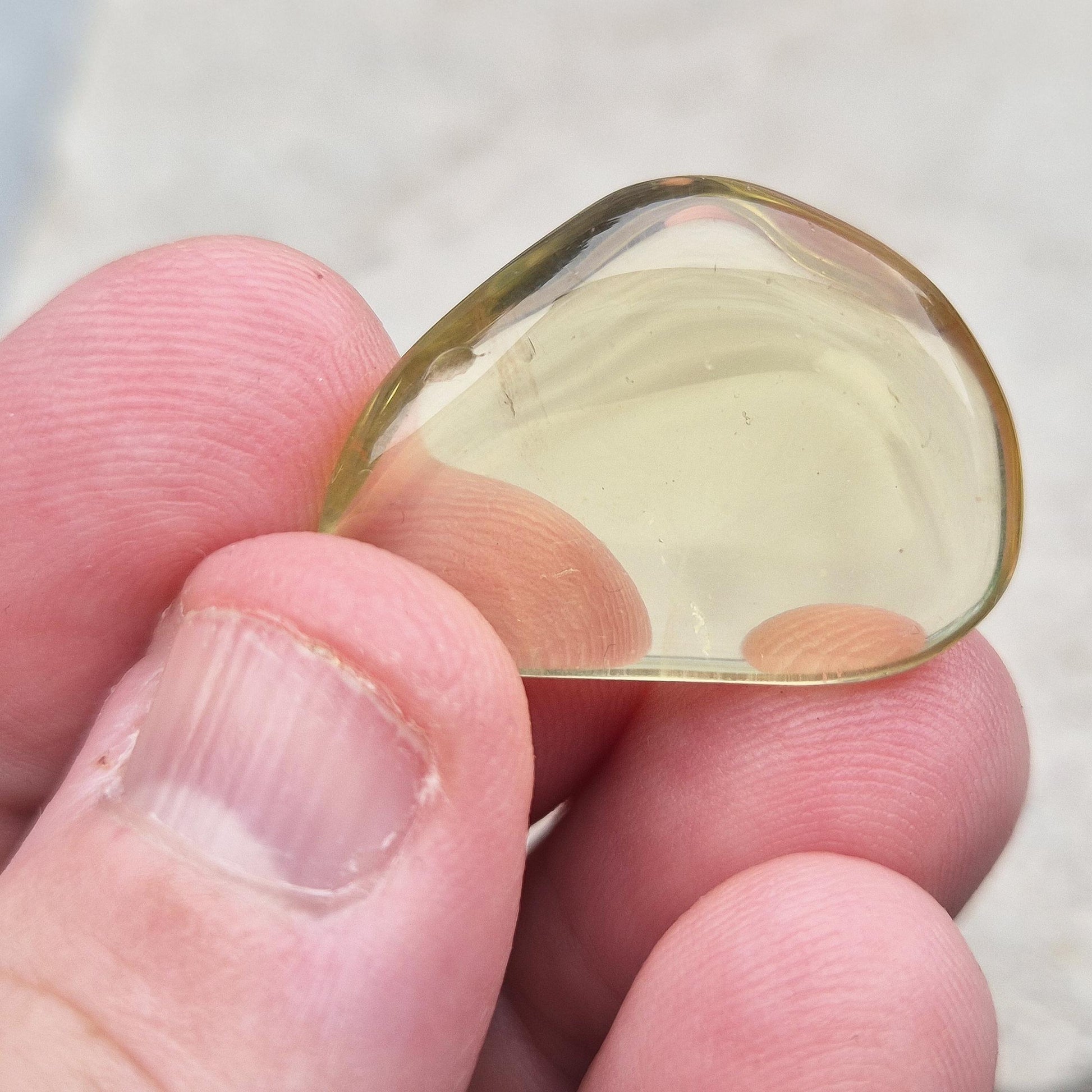 Ouro Verde Quartz tumblestone with olive-green tone. Treated crystal from Brazil for protection, clarity, and personal strength. 