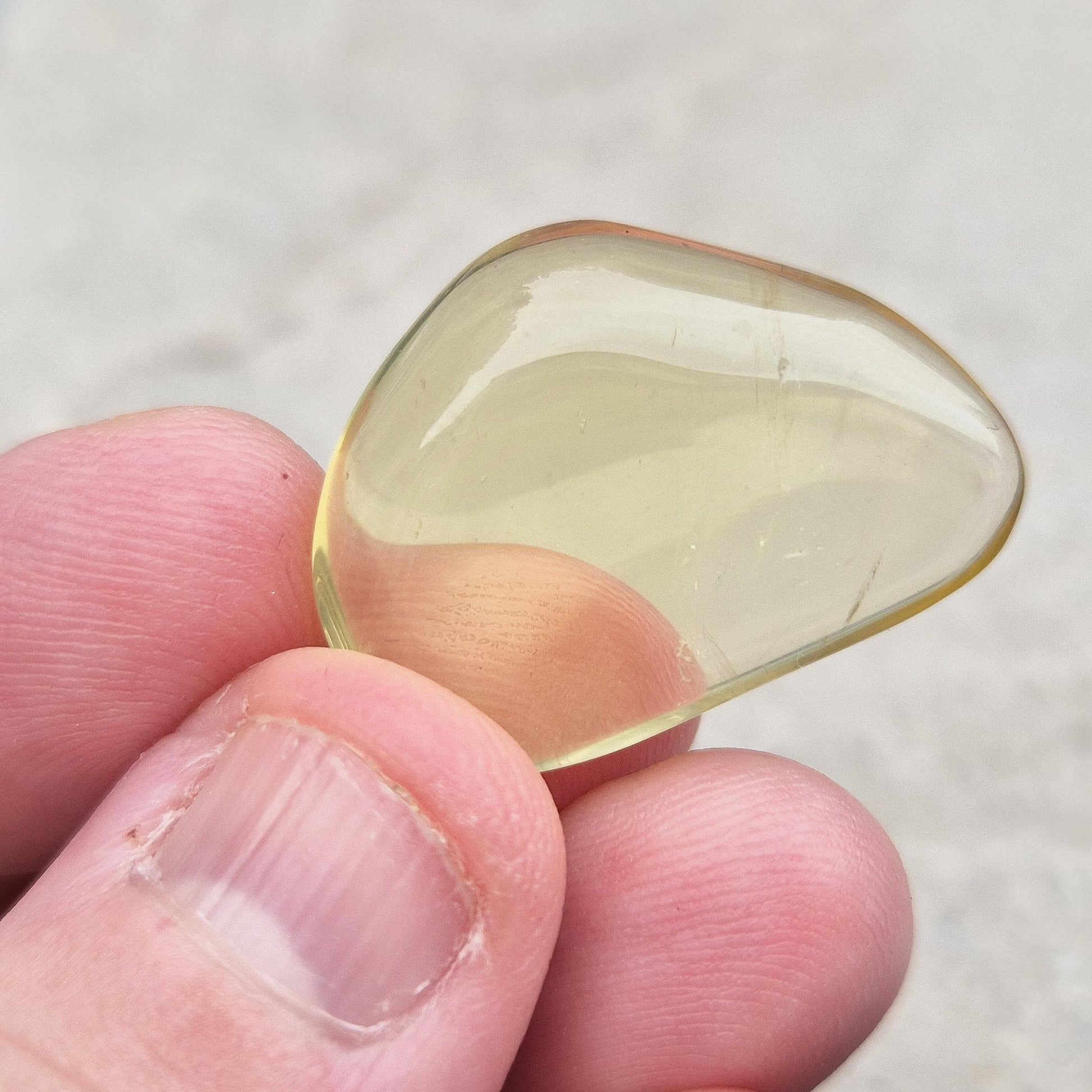 Ouro Verde Quartz tumblestone with olive-green tone. Treated crystal from Brazil for protection, clarity, and personal strength. 