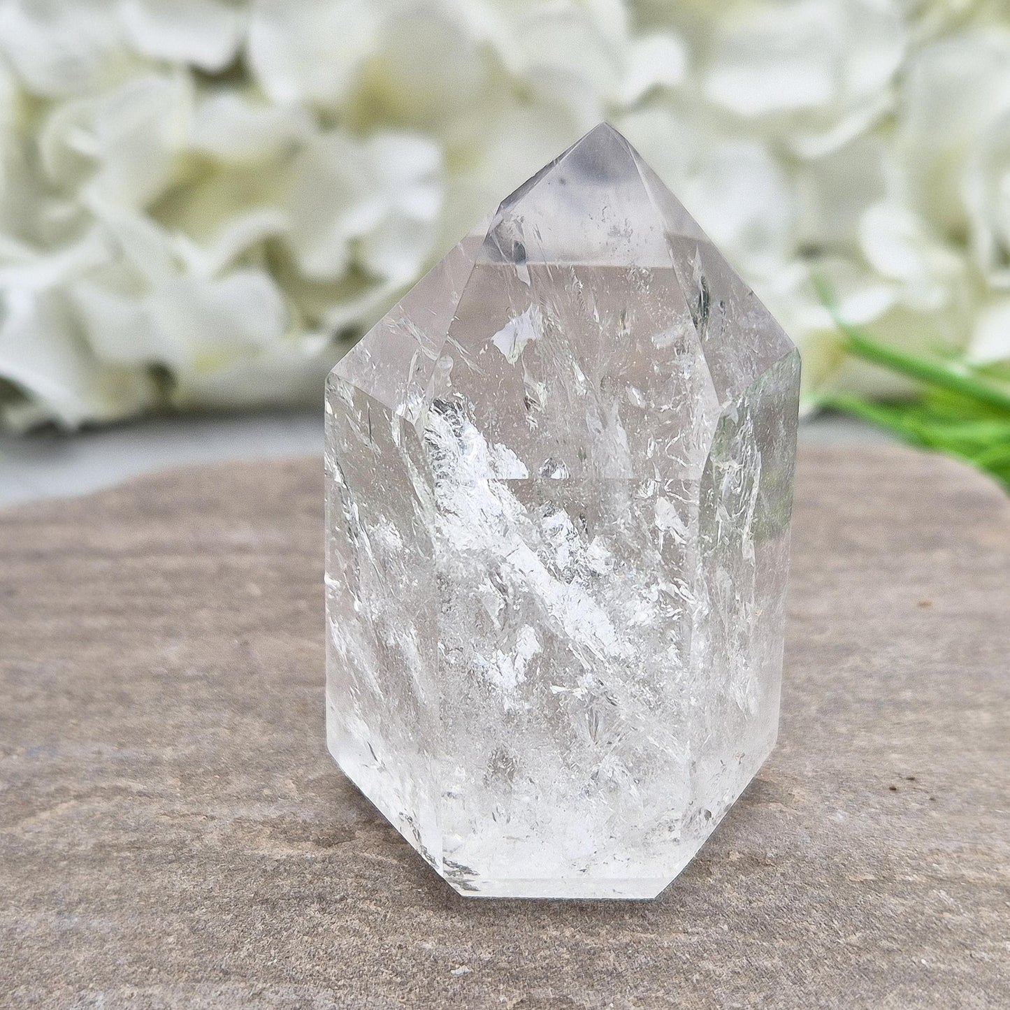 Polished Clear Quartz point from Brazil with sparkling inclusions. High vibration, versatile energy—perfect for clarity, healing, and spiritual focus. 