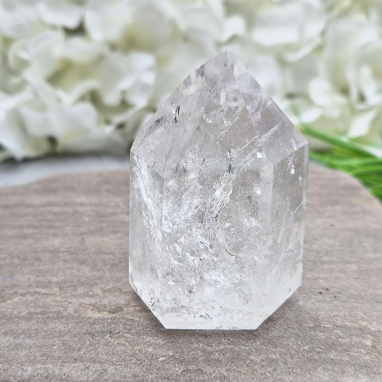 Polished Clear Quartz point from Brazil with sparkling inclusions. High vibration, versatile energy—perfect for clarity, healing, and spiritual focus. 