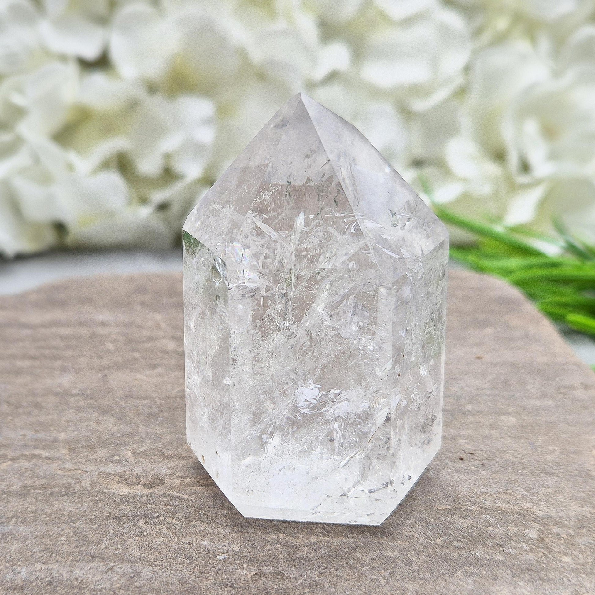 Polished Clear Quartz point from Brazil with sparkling inclusions. High vibration, versatile energy—perfect for clarity, healing, and spiritual focus. 
