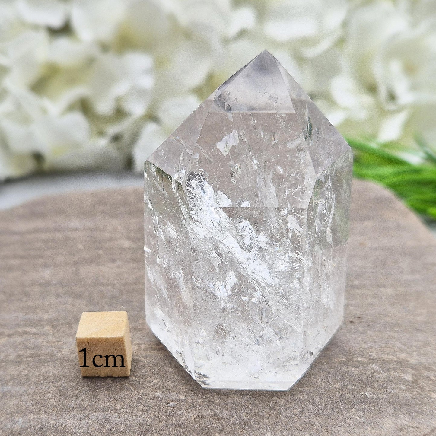 Quartz Polished Crystal Point filled with light reflecting inclusions