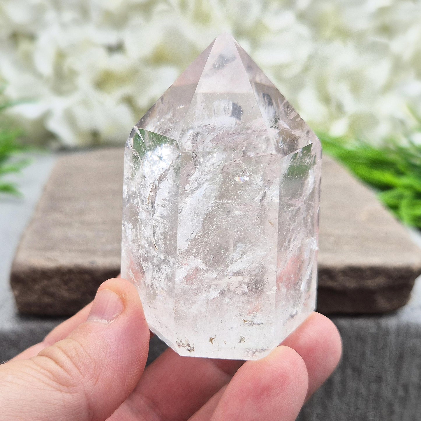 Quartz Polished Crystal Point filled with light reflecting inclusions