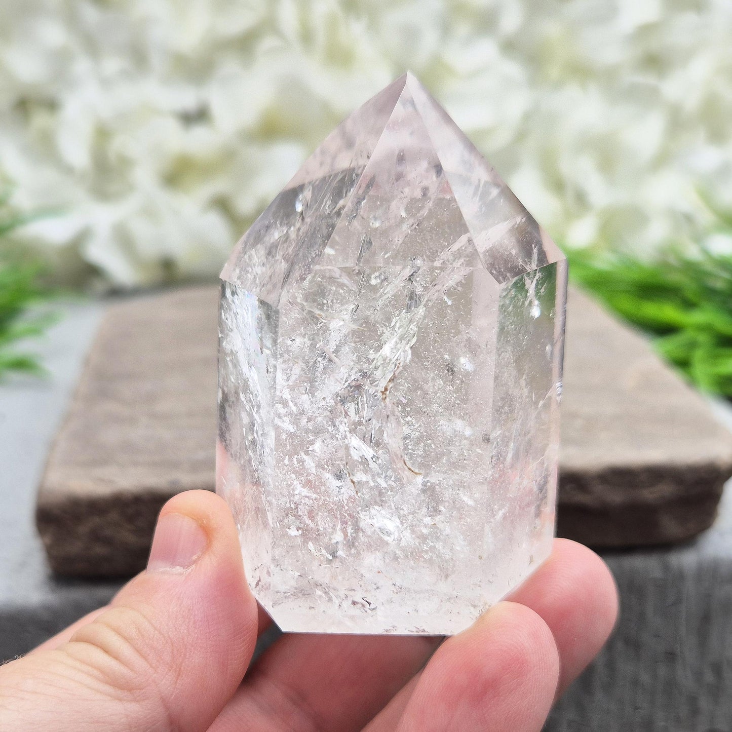 Quartz Polished Crystal Point filled with light reflecting inclusions