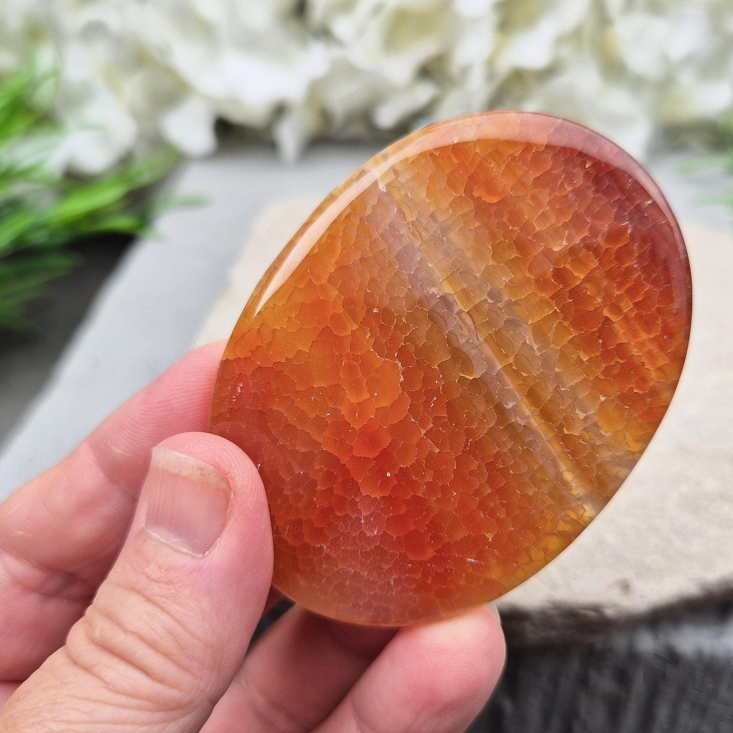 Fire Agate palmstone from Mexico – grounding and protective energy. A calming crystal that boosts vitality, confidence, and inner strength. 