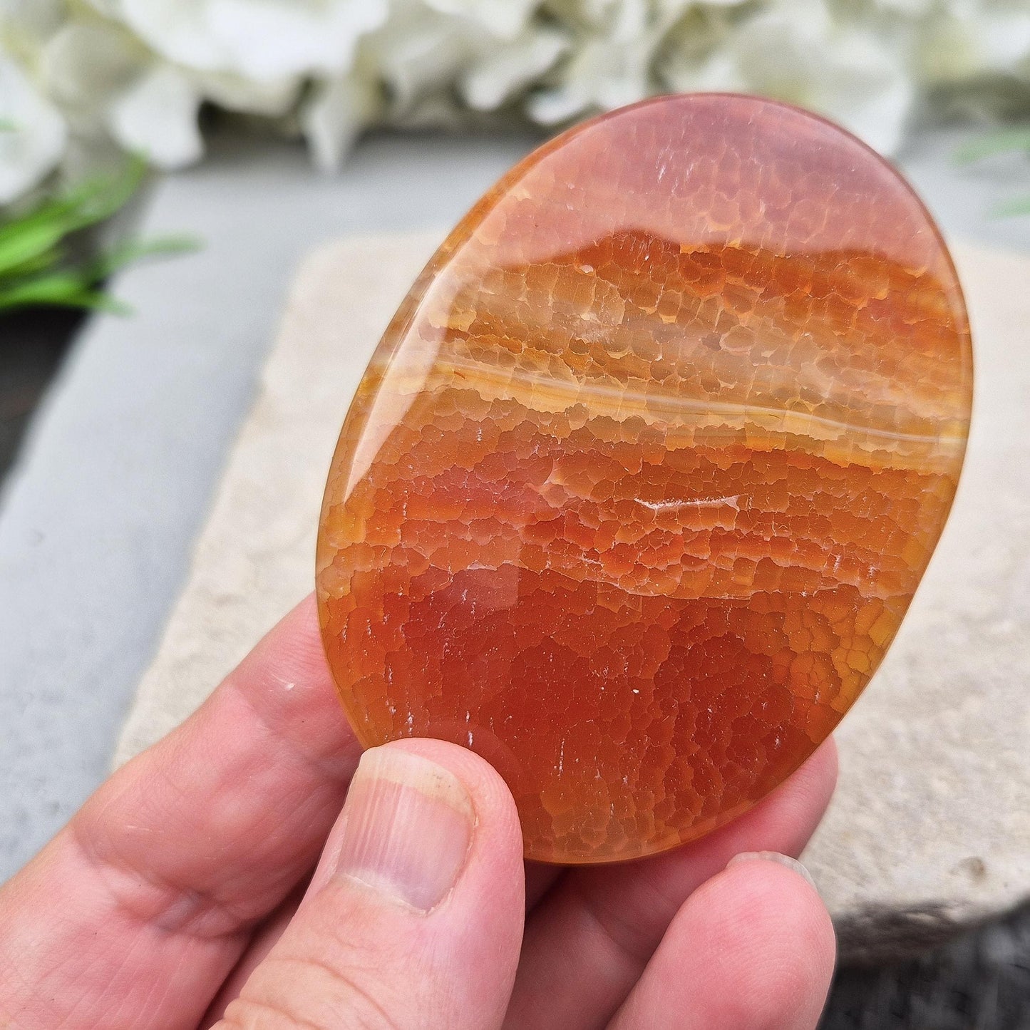 Fire Agate palmstone from Mexico – grounding and protective energy. A calming crystal that boosts vitality, confidence, and inner strength. 