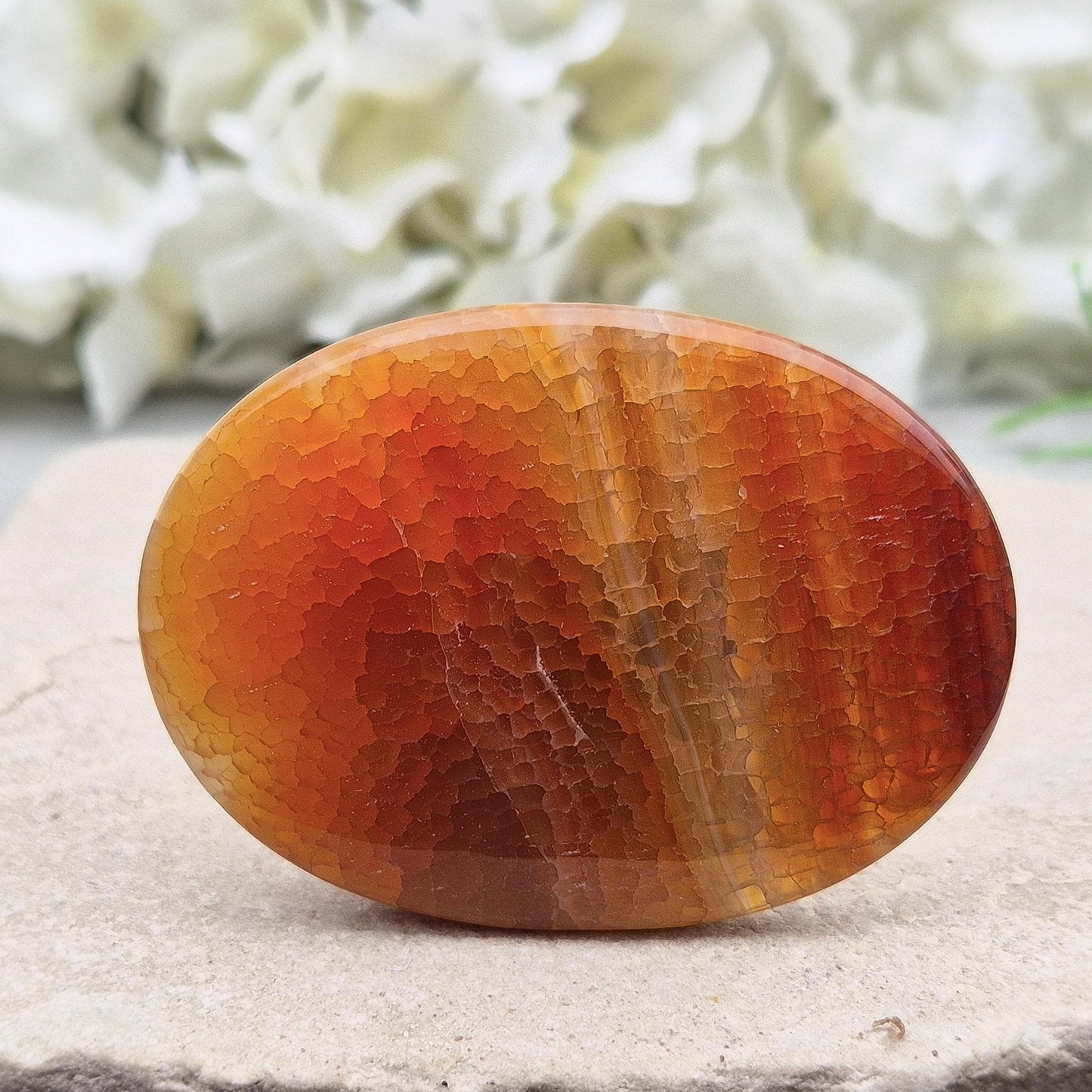 Fire Agate palmstone from Mexico – grounding and protective energy. A calming crystal that boosts vitality, confidence, and inner strength. 