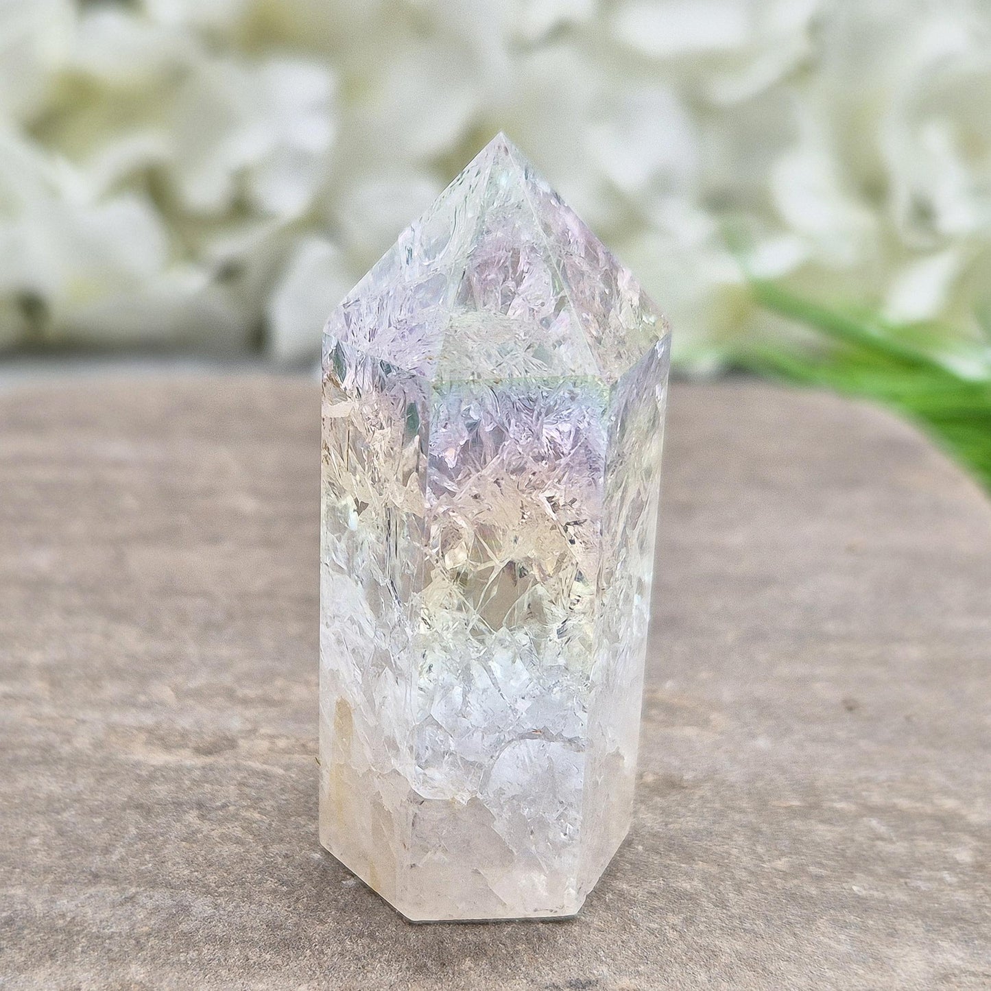 Fire and Ice Aura Quartz with internal rainbow fracturing. A polished crystal for display, positive energy, focus, and meditation.