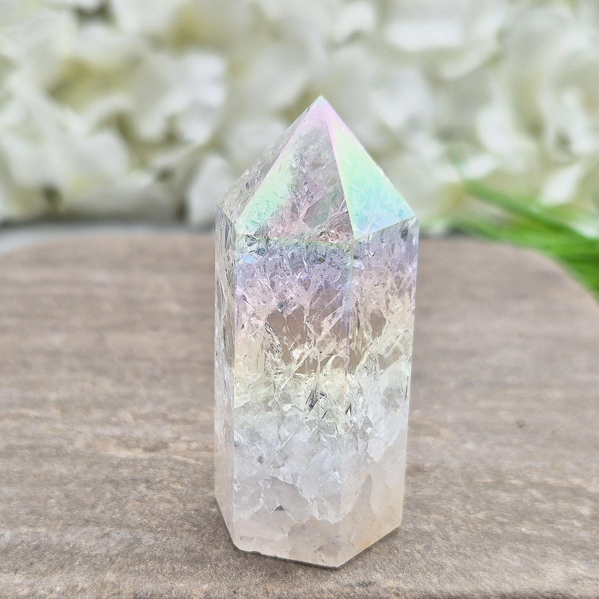 Fire and Ice Aura Quartz with internal rainbow fracturing. A polished crystal for display, positive energy, focus, and meditation.