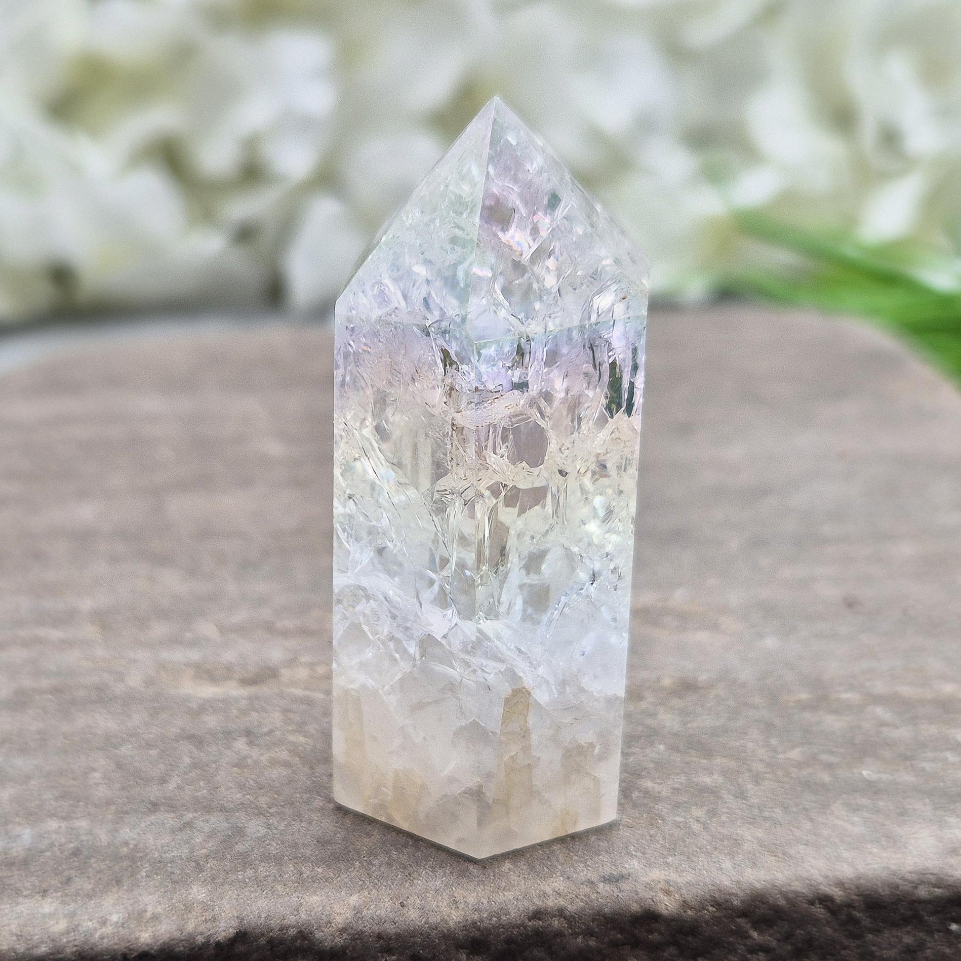 Fire and Ice Aura Quartz with internal rainbow fracturing. A polished crystal for display, positive energy, focus, and meditation.