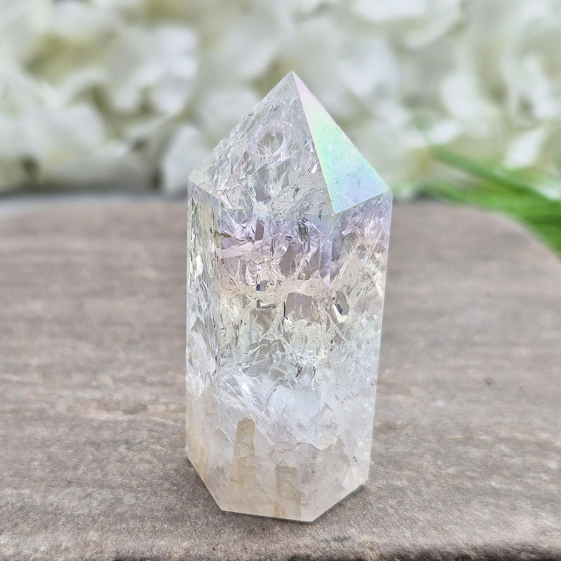 Fire and Ice Aura Quartz with internal rainbow fracturing. A polished crystal for display, positive energy, focus, and meditation.