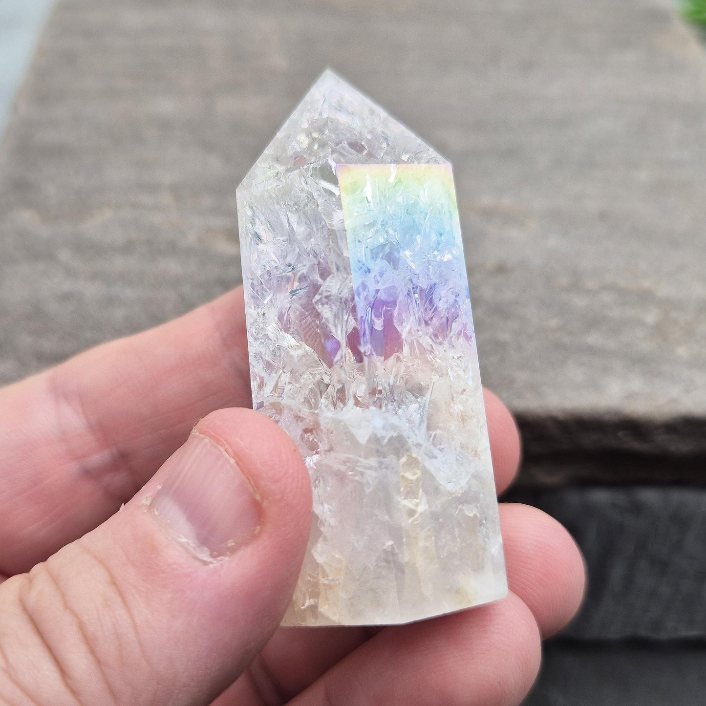 Fire and Ice Aura Quartz with internal rainbow fracturing. A polished crystal for display, positive energy, focus, and meditation.