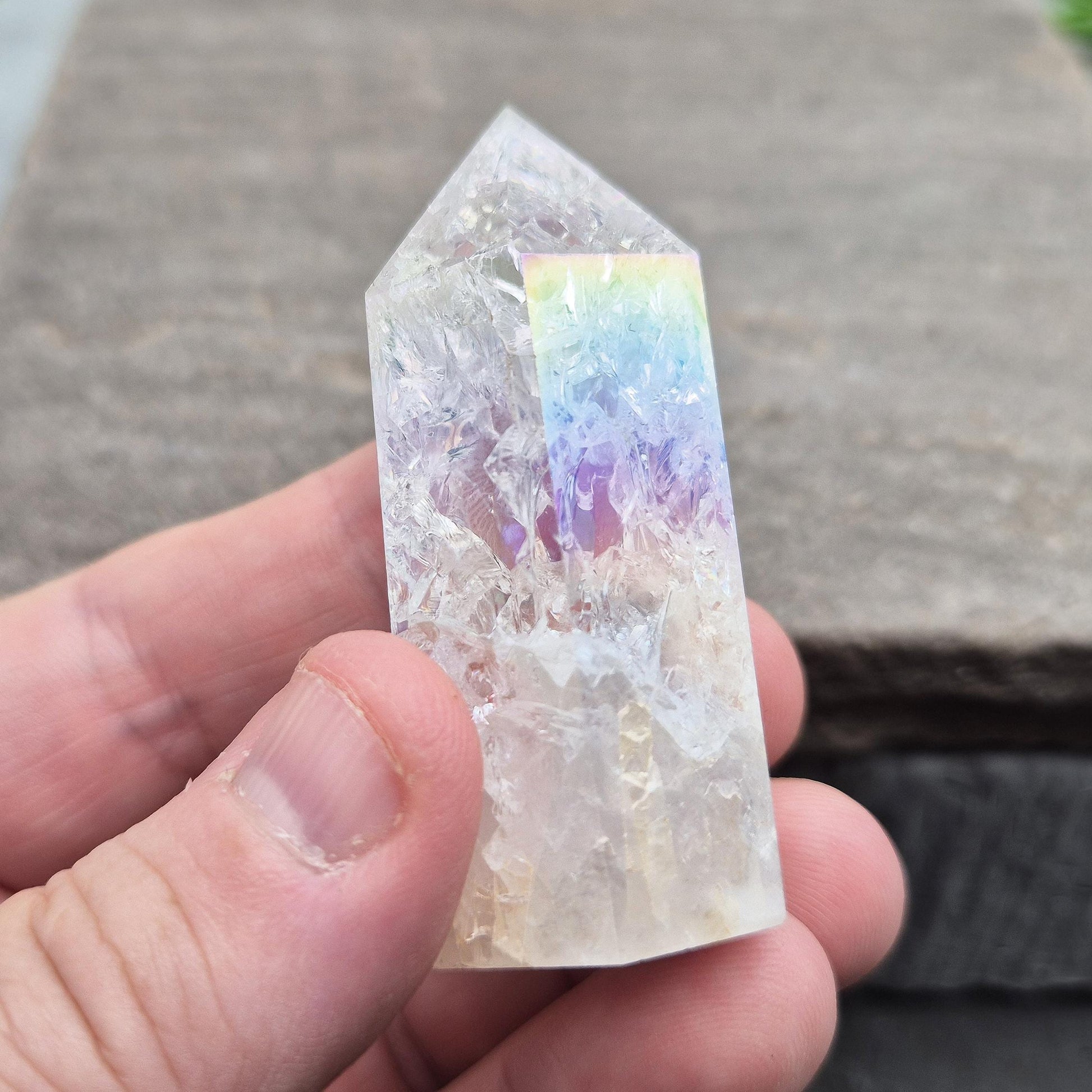 Fire and Ice Aura Quartz with internal rainbow fracturing. A polished crystal for display, positive energy, focus, and meditation.
