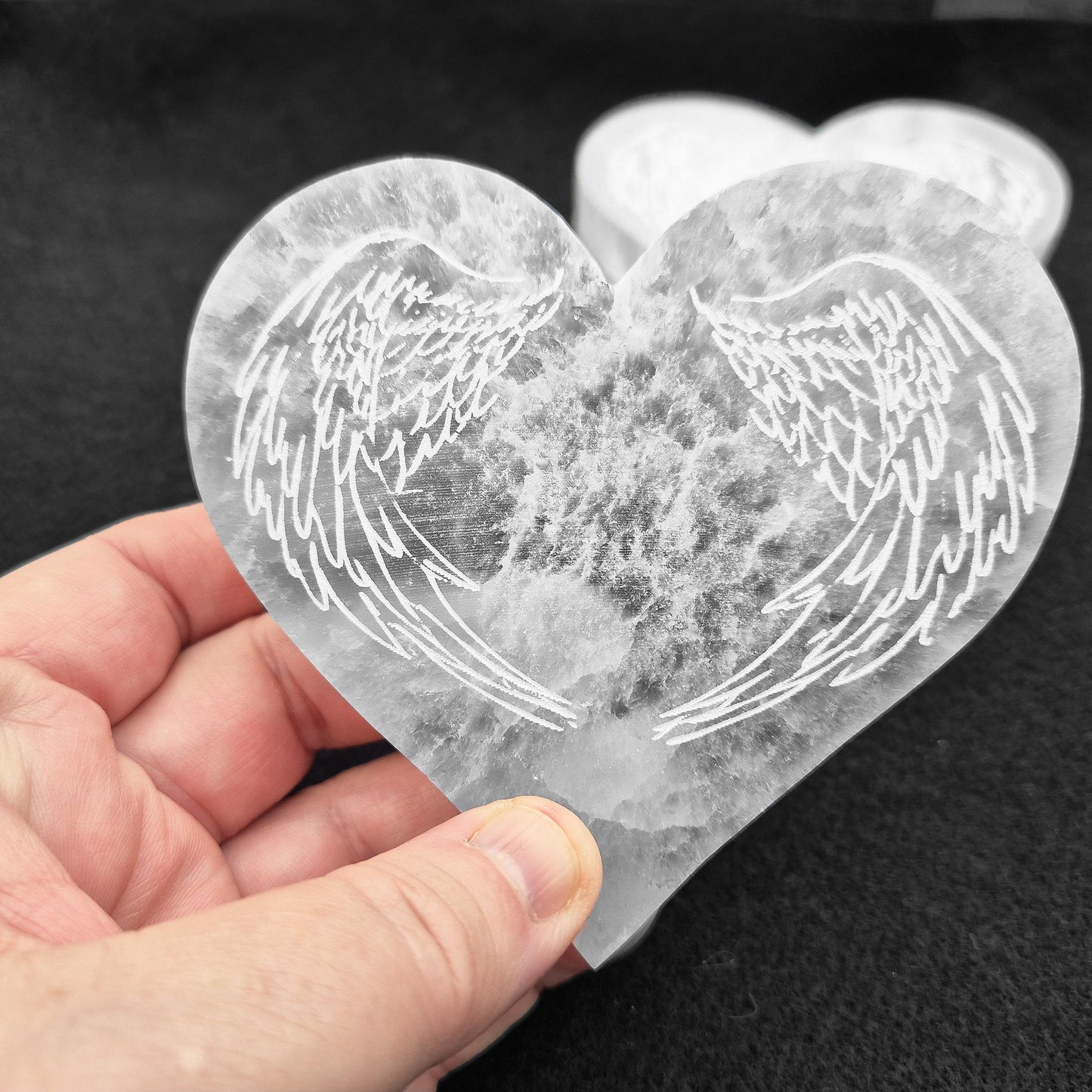 Selenite Heart Shaped Tiles etched with Angel Wings – A polished, serene crystal that adds tranquility and beauty to any space, perfect for uplifting energy.