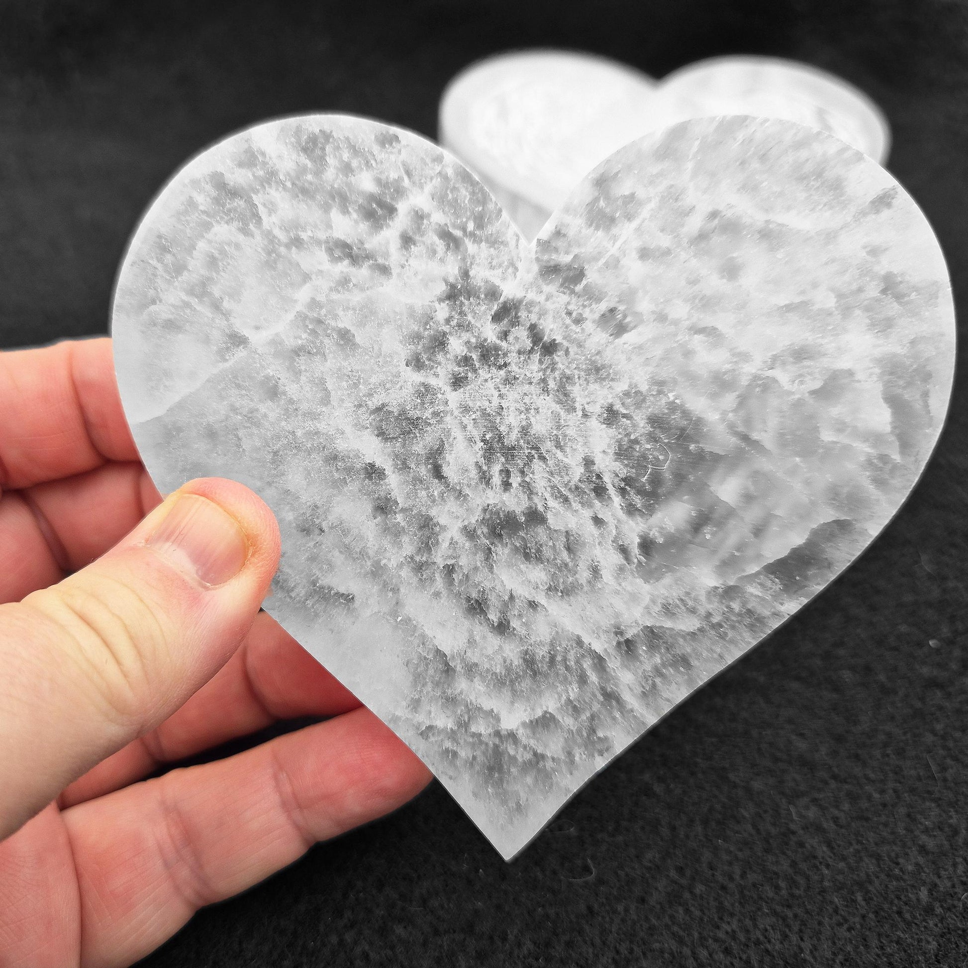 Selenite Heart Shaped Tiles etched with Angel Wings – A polished, serene crystal that adds tranquility and beauty to any space, perfect for uplifting energy.
