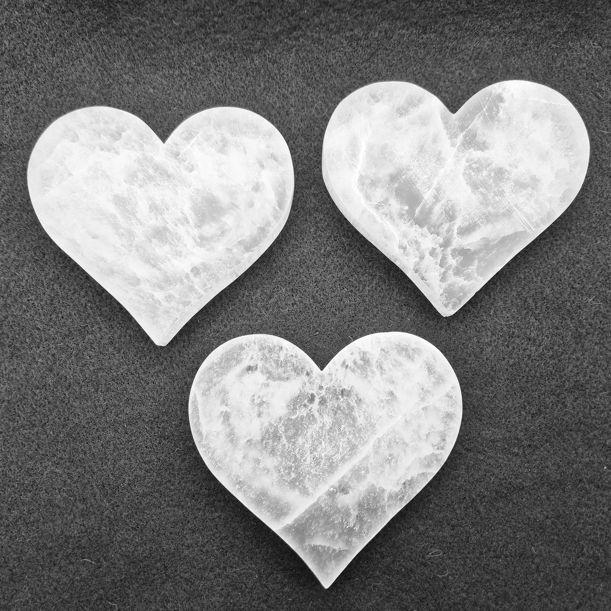 Selenite Heart Shaped Tiles etched with Angel Wings – A polished, serene crystal that adds tranquility and beauty to any space, perfect for uplifting energy.