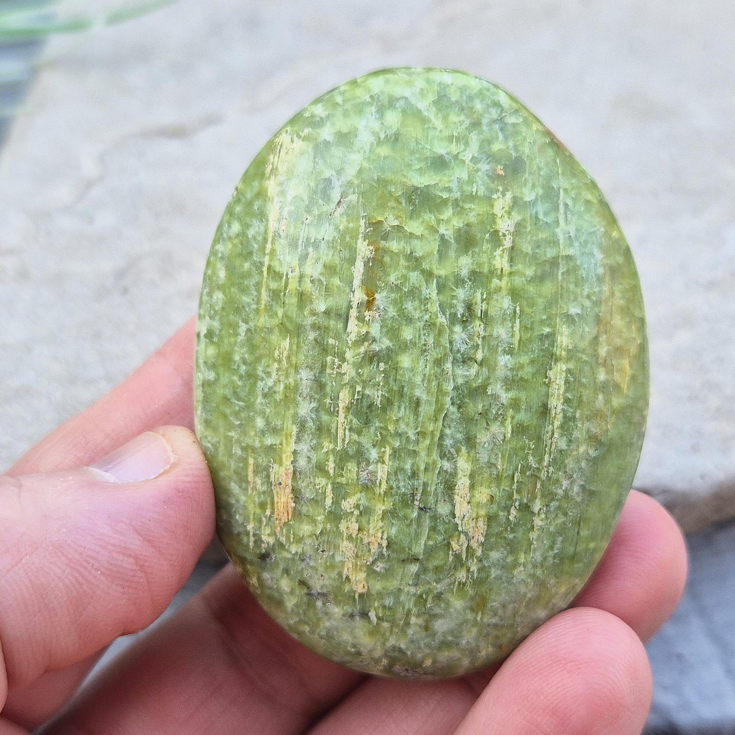 Tremolite palm stone – A polished crystal, perfect for mindful practices, promoting tranquility, and adding a serene touch to any space.