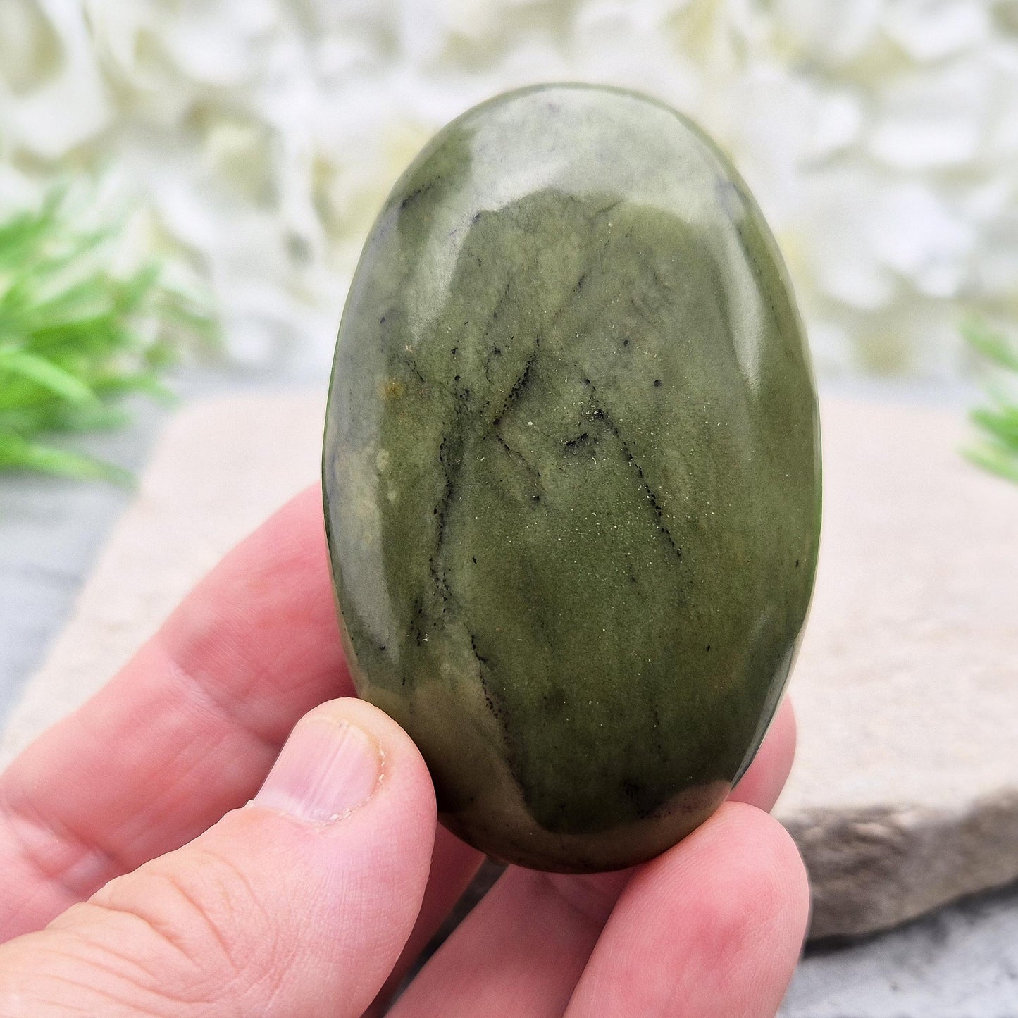 Nephrite Jade palm stone for calm, protection, and emotional balance. A soothing crystal to ease stress and support the heart. 