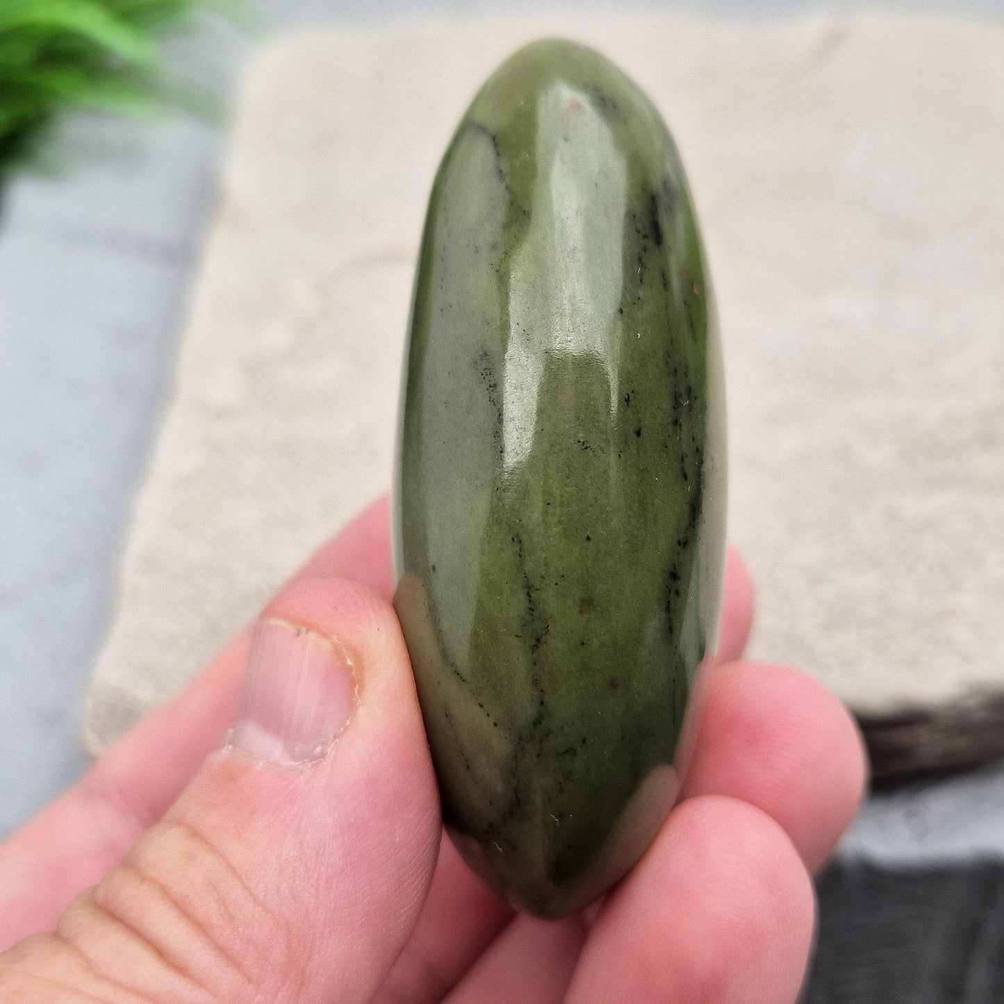 Nephrite Jade palm stone for calm, protection, and emotional balance. A soothing crystal to ease stress and support the heart. 