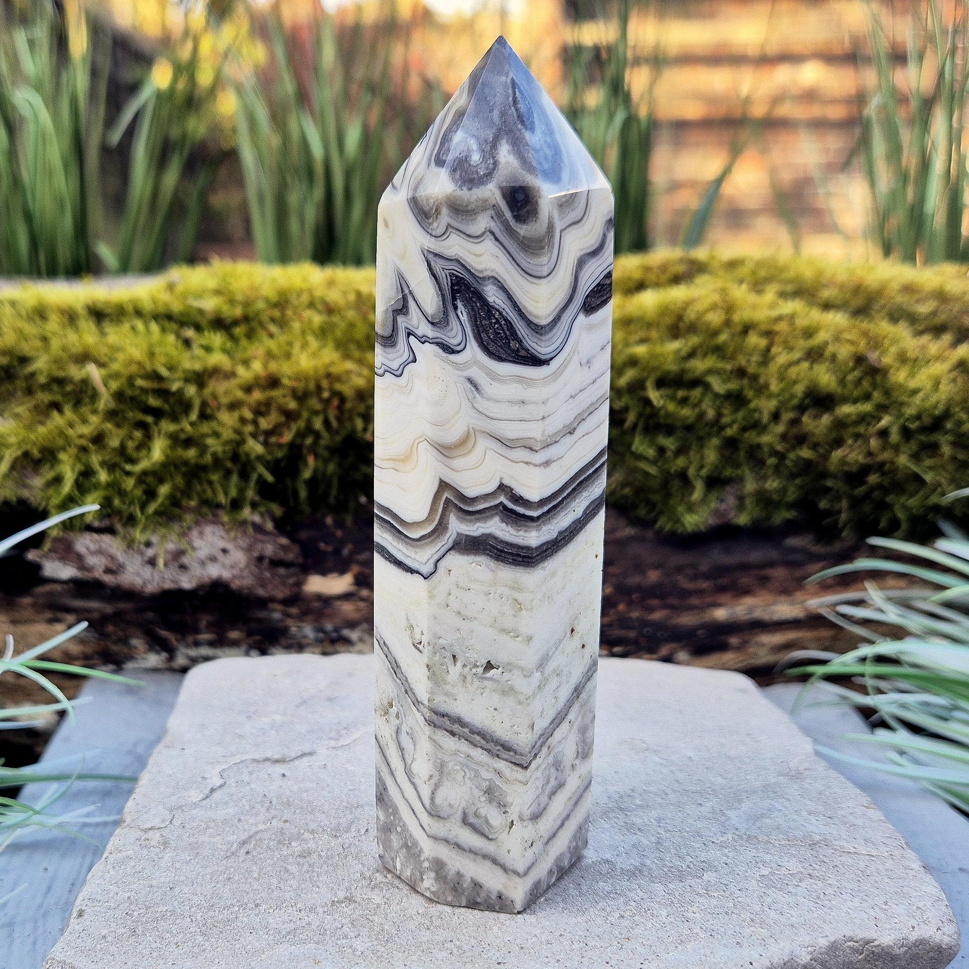 Zebra Calcite Point – Encourages self-awareness, clarity, and calm. A powerful tool for growth, balance, and emotional strength.
