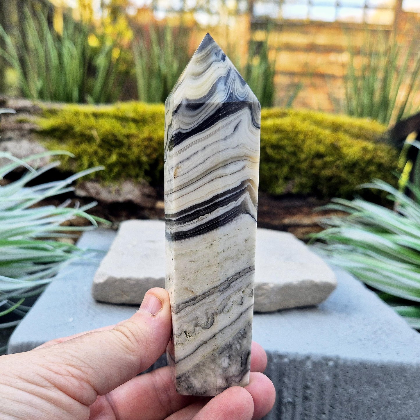 Zebra Calcite Point – Encourages self-awareness, clarity, and calm. A powerful tool for growth, balance, and emotional strength.