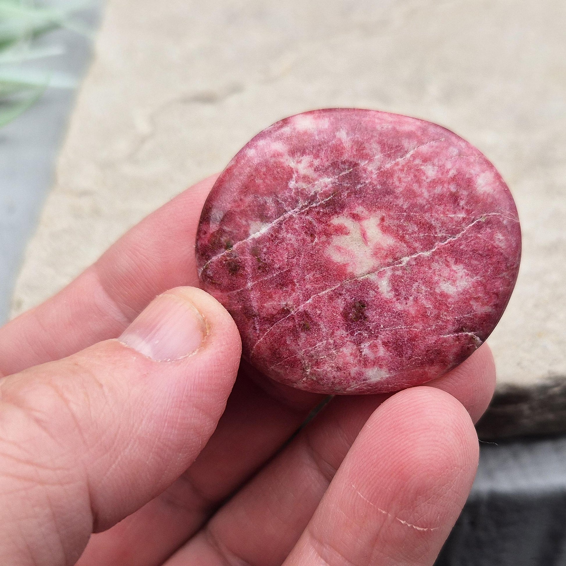 Pink Thulite palm stone – handpicked for heart and sacral chakra support. Encourages passion, creativity, and healthy emotional expression.