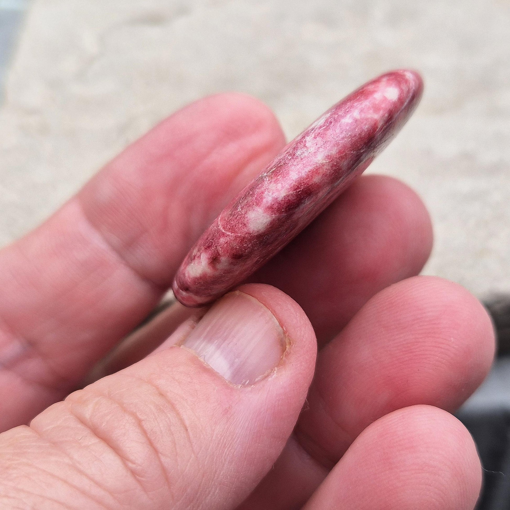 Pink Thulite palm stone – handpicked for heart and sacral chakra support. Encourages passion, creativity, and healthy emotional expression.