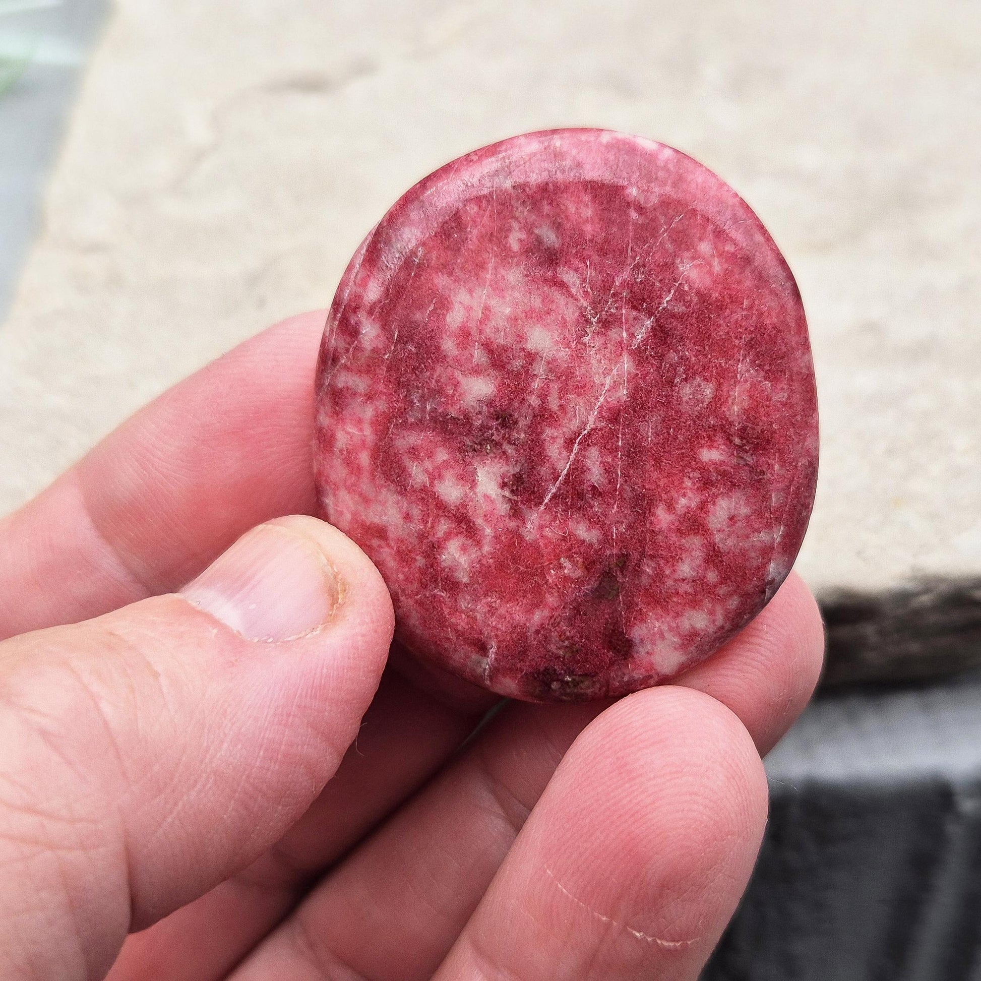 Pink Thulite palm stone – handpicked for heart and sacral chakra support. Encourages passion, creativity, and healthy emotional expression.
